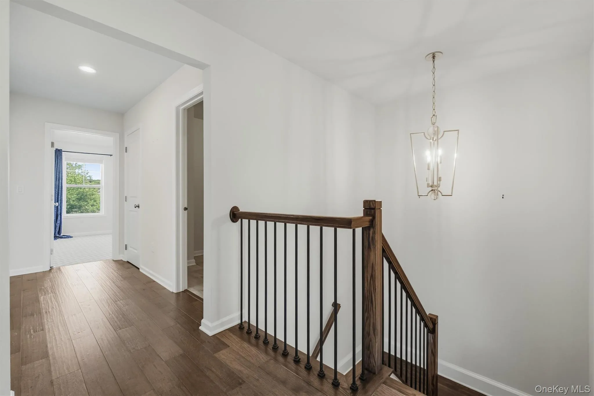 Hardwood-finish flooring extending through the hallway. Hardwood-finish flooring extending through the hallway.