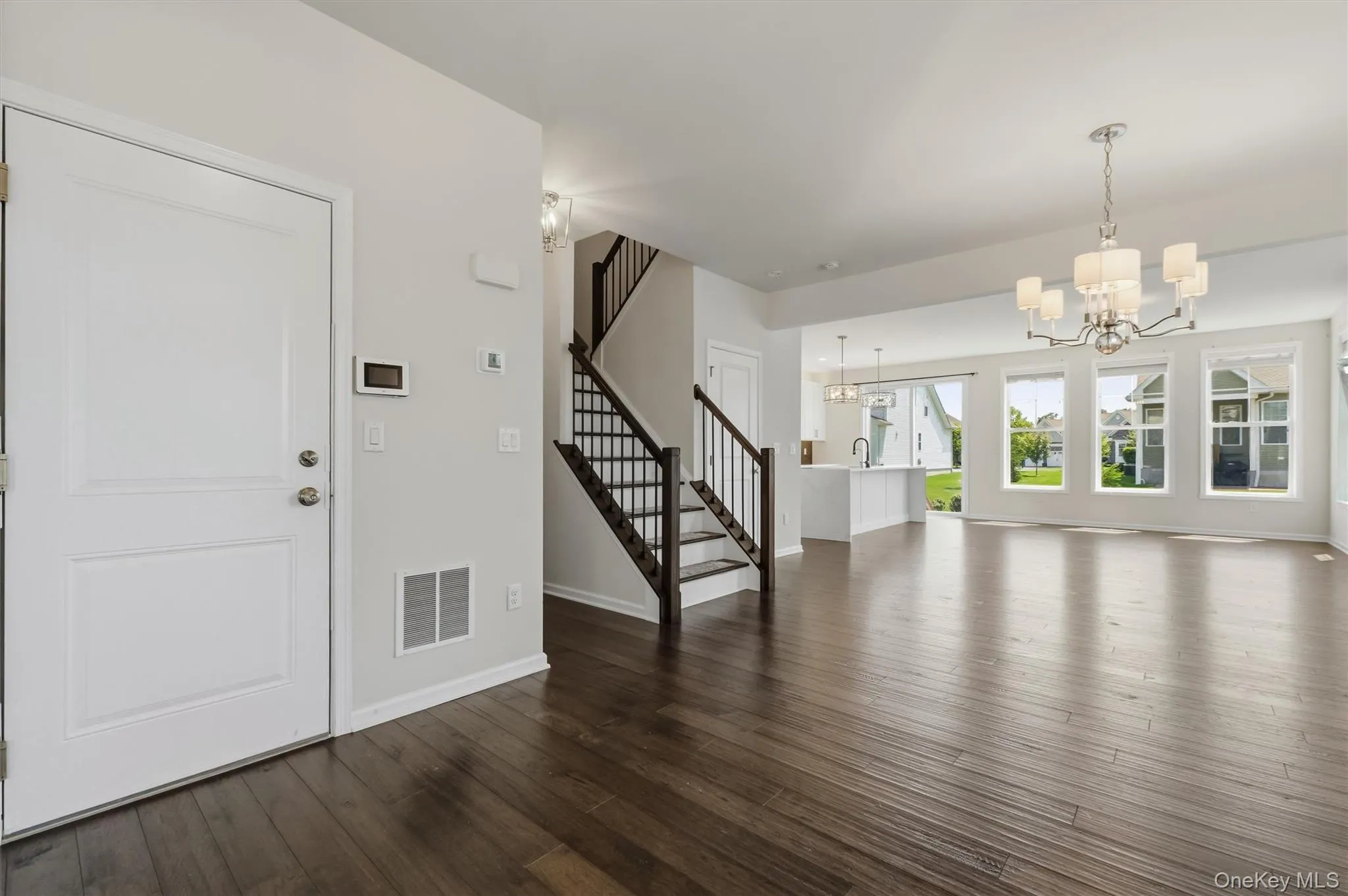 Entrance foyer looking towards dining room, living room and kitchen. Entrance foyer looking towards dining room, living room and kitchen.