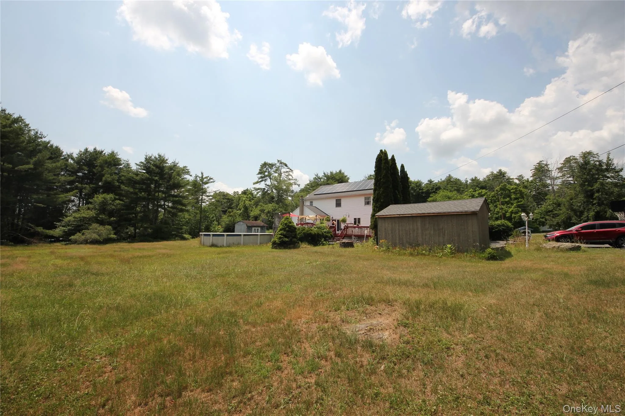 Expansive, level lot featuring a detached shed, perimeter fencing, and mature trees bordering the property Expansive, level lot featuring a detached shed, perimeter fencing, and mature trees bordering the property