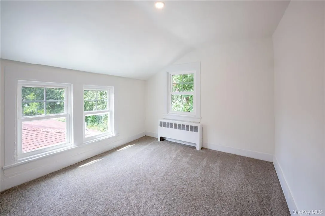 Bedroom 4 has a lofted ceiling, and carpet Bedroom 4 has a lofted ceiling, and carpet