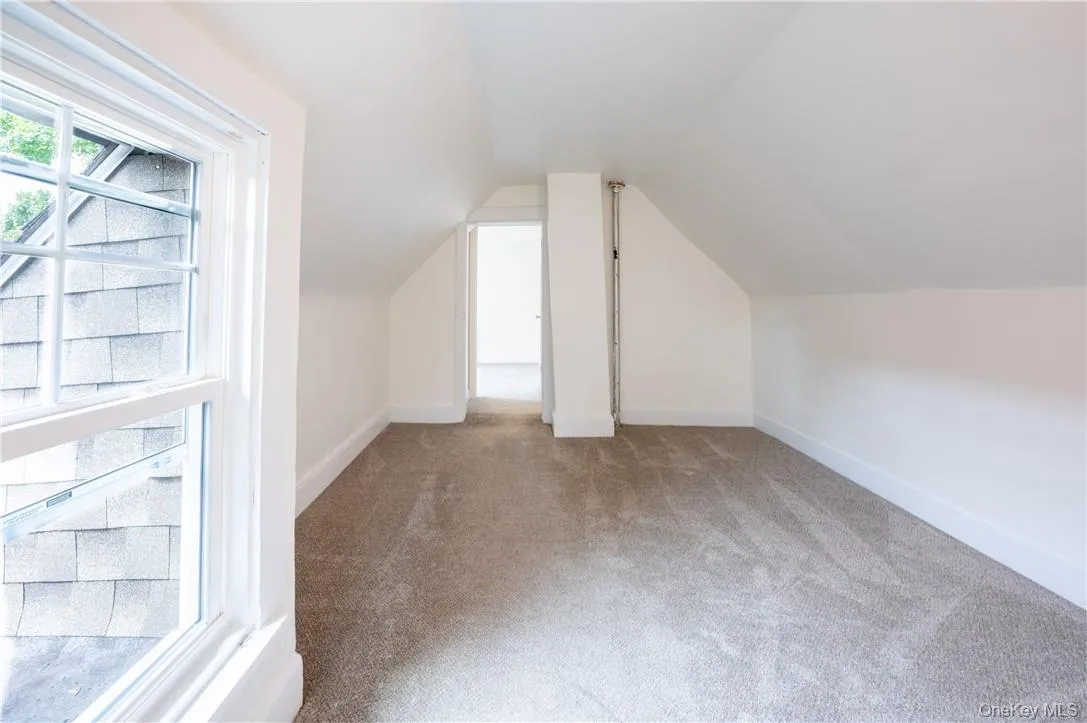 Bedroom 3 with carpet flooring and vaulted ceiling Bedroom 3 with carpet flooring and vaulted ceiling