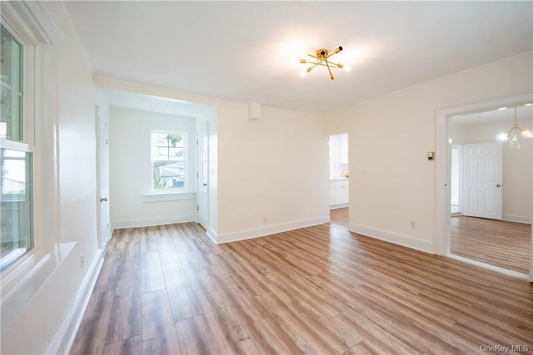The living room has plenty of natural light and a notable chandelier The living room has plenty of natural light and a notable chandelier