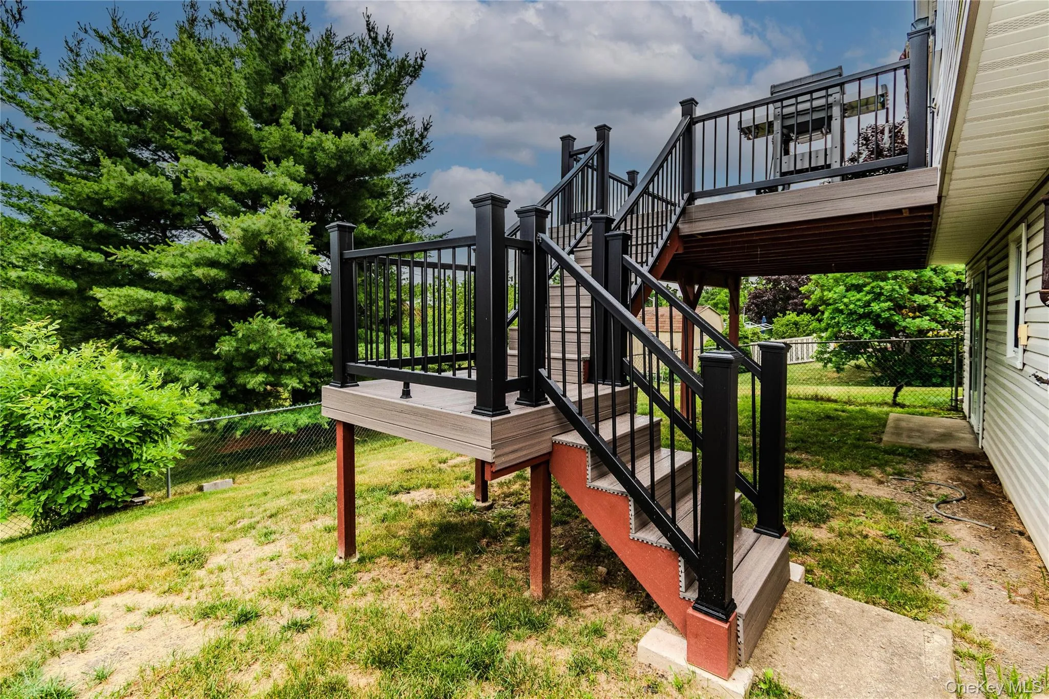 Backyard from driveway - trex deck Backyard from driveway - trex deck