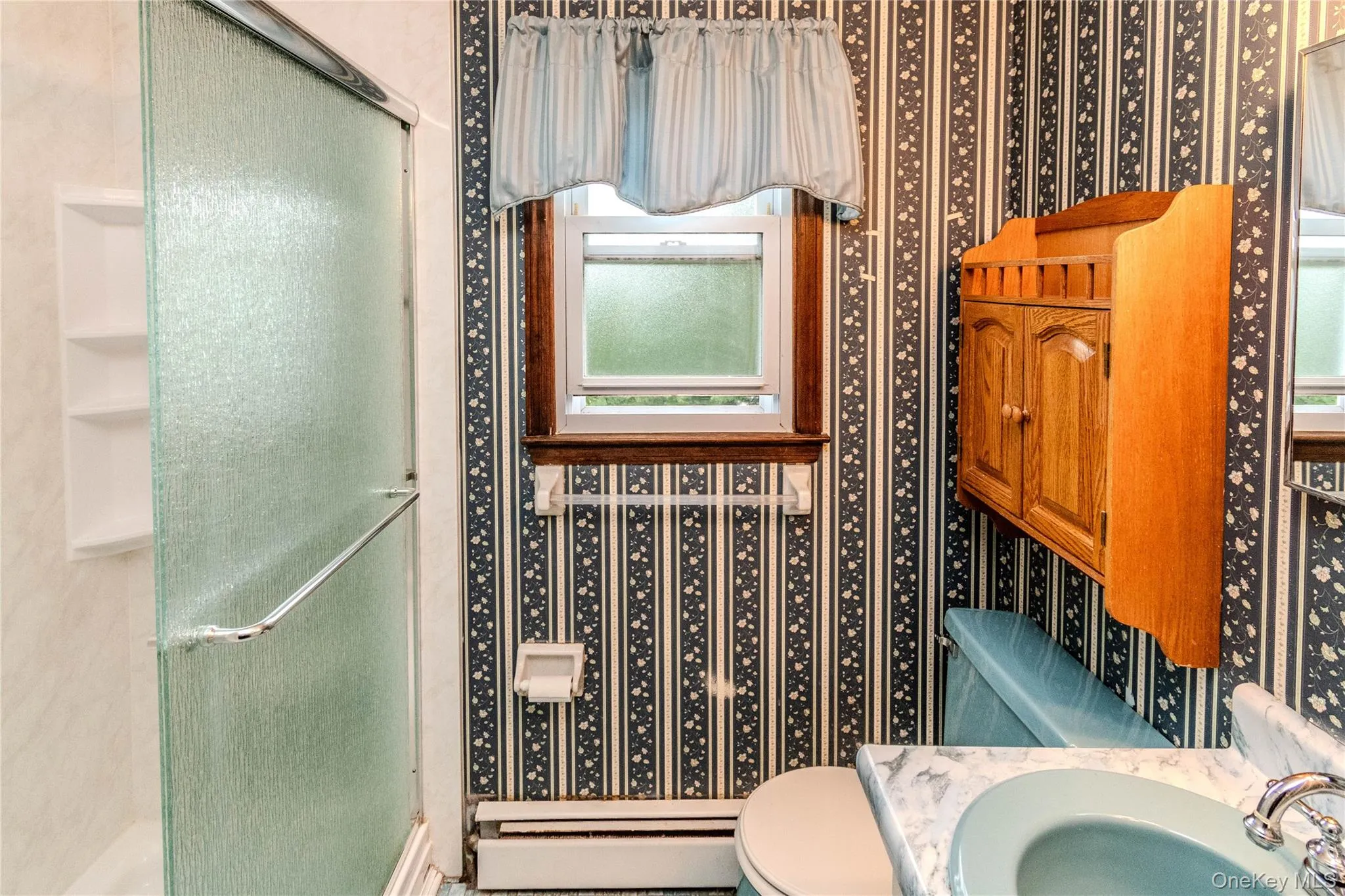 Bathroom 1 - Single vanity sink with walk in shower. Door connects to ensuite half bathroom. Bathroom 1 - Single vanity sink with walk in shower. Door connects to ensuite half bathroom.