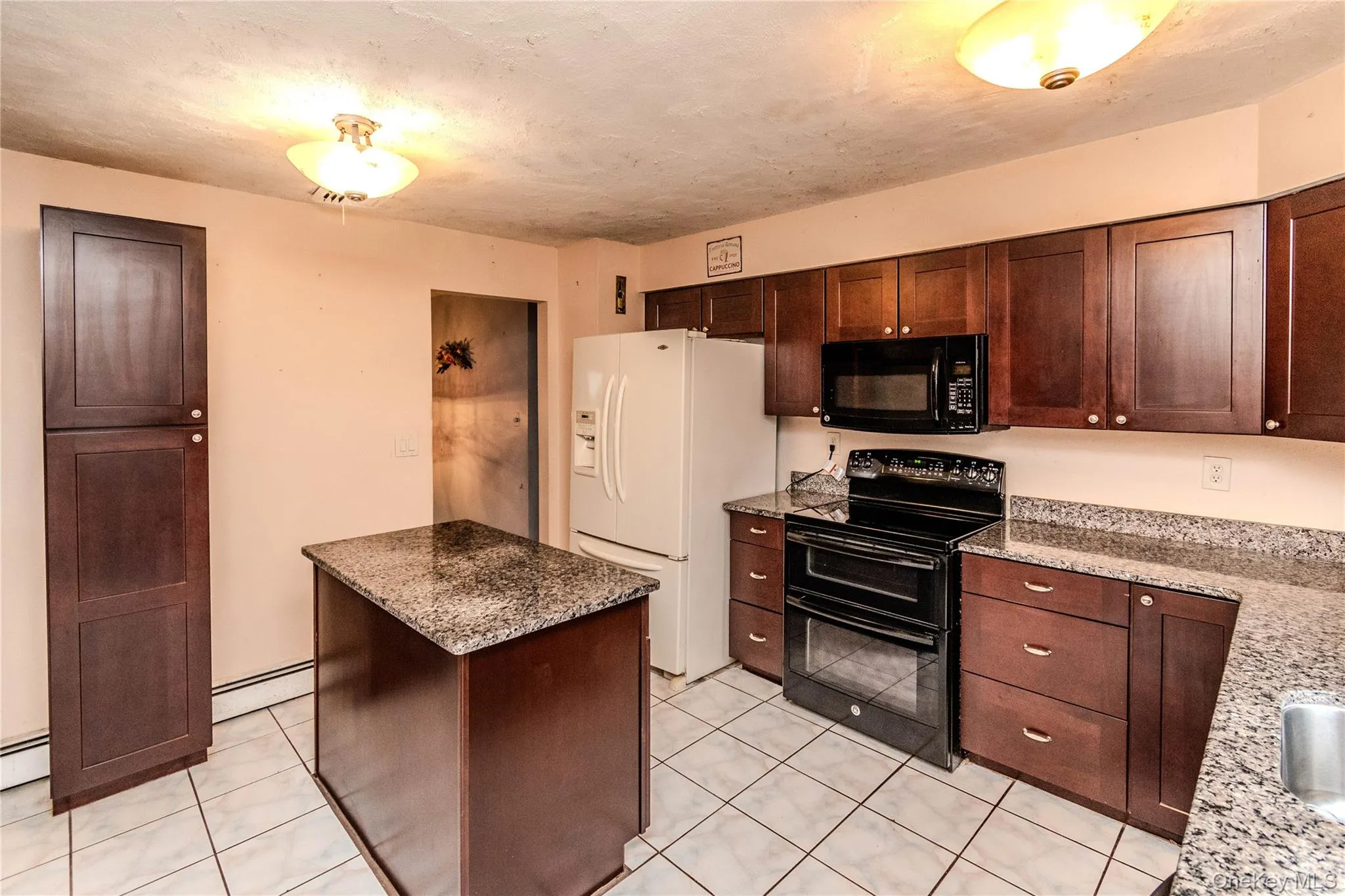 Kitchen - Granite counter top, electric range, island, tile Kitchen - Granite counter top, electric range, island, tile
