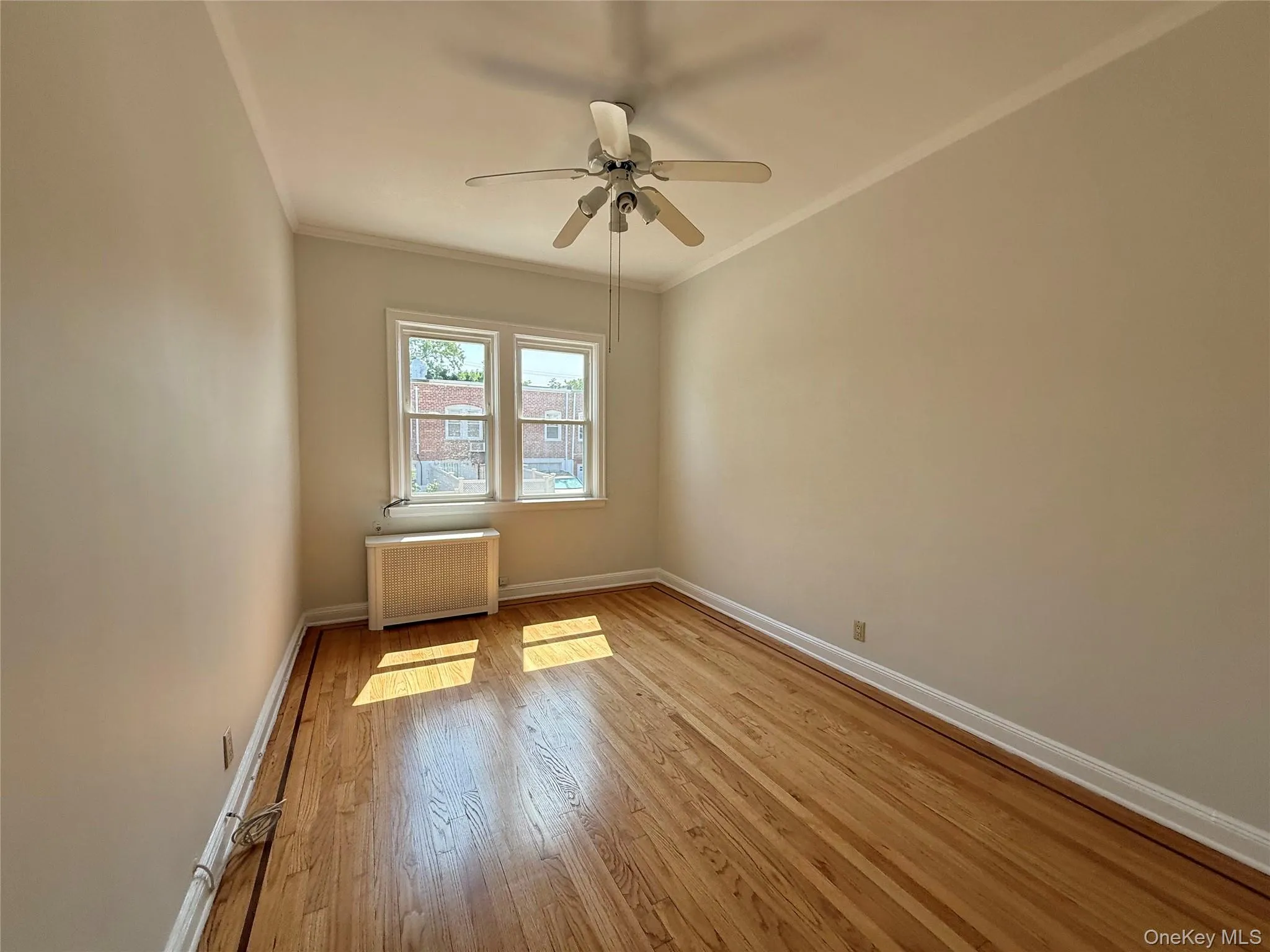 Second bedroom with elegant hardwood flooring, a ceiling fan with light fixture, 2 windows, large closet Second bedroom with elegant hardwood flooring, a ceiling fan with light fixture, 2 windows, large closet