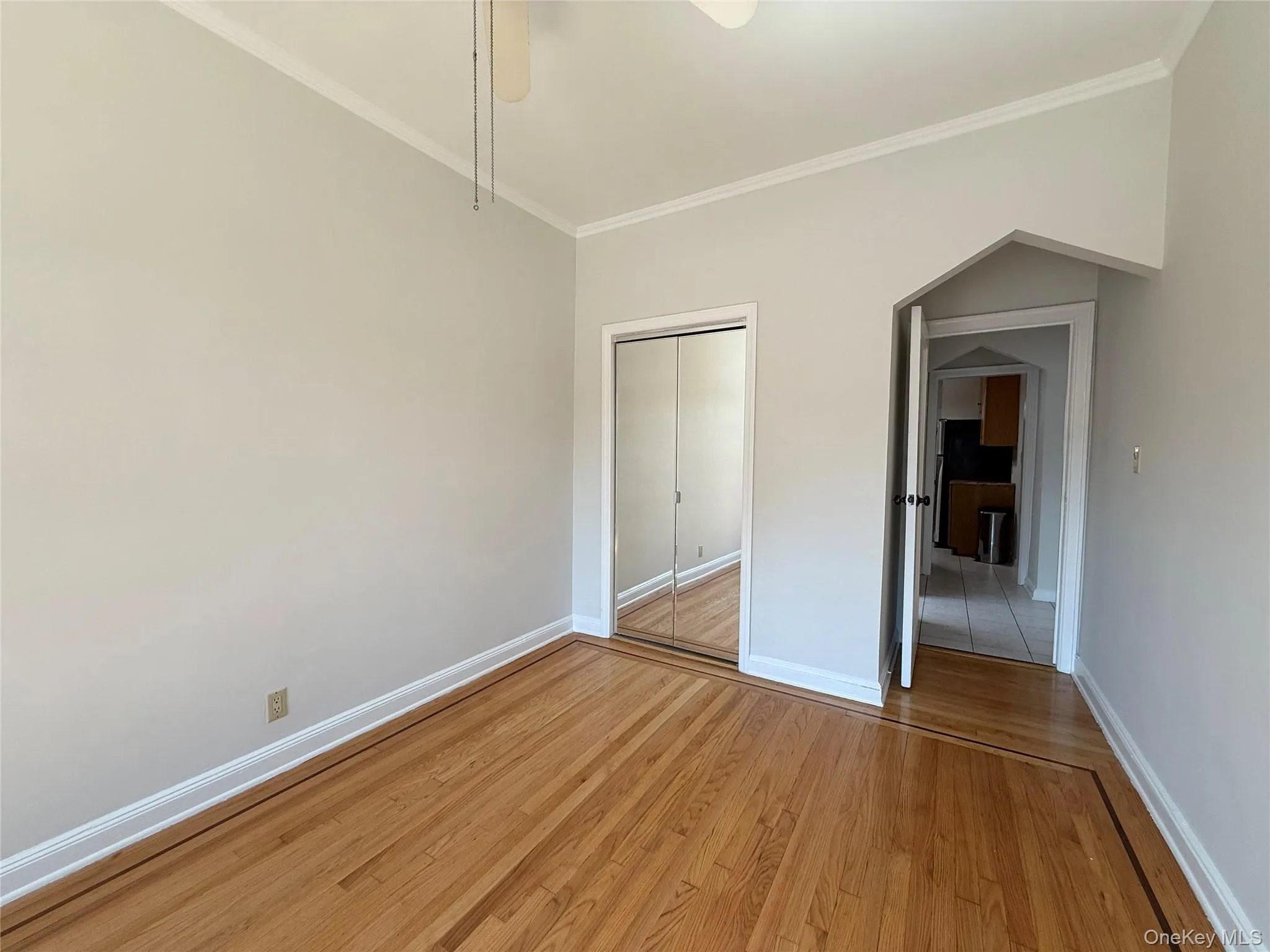 Second bedroom with elegant hardwood flooring, a ceiling fan with light fixture, 2 windows, large closet Second bedroom with elegant hardwood flooring, a ceiling fan with light fixture, 2 windows, large closet