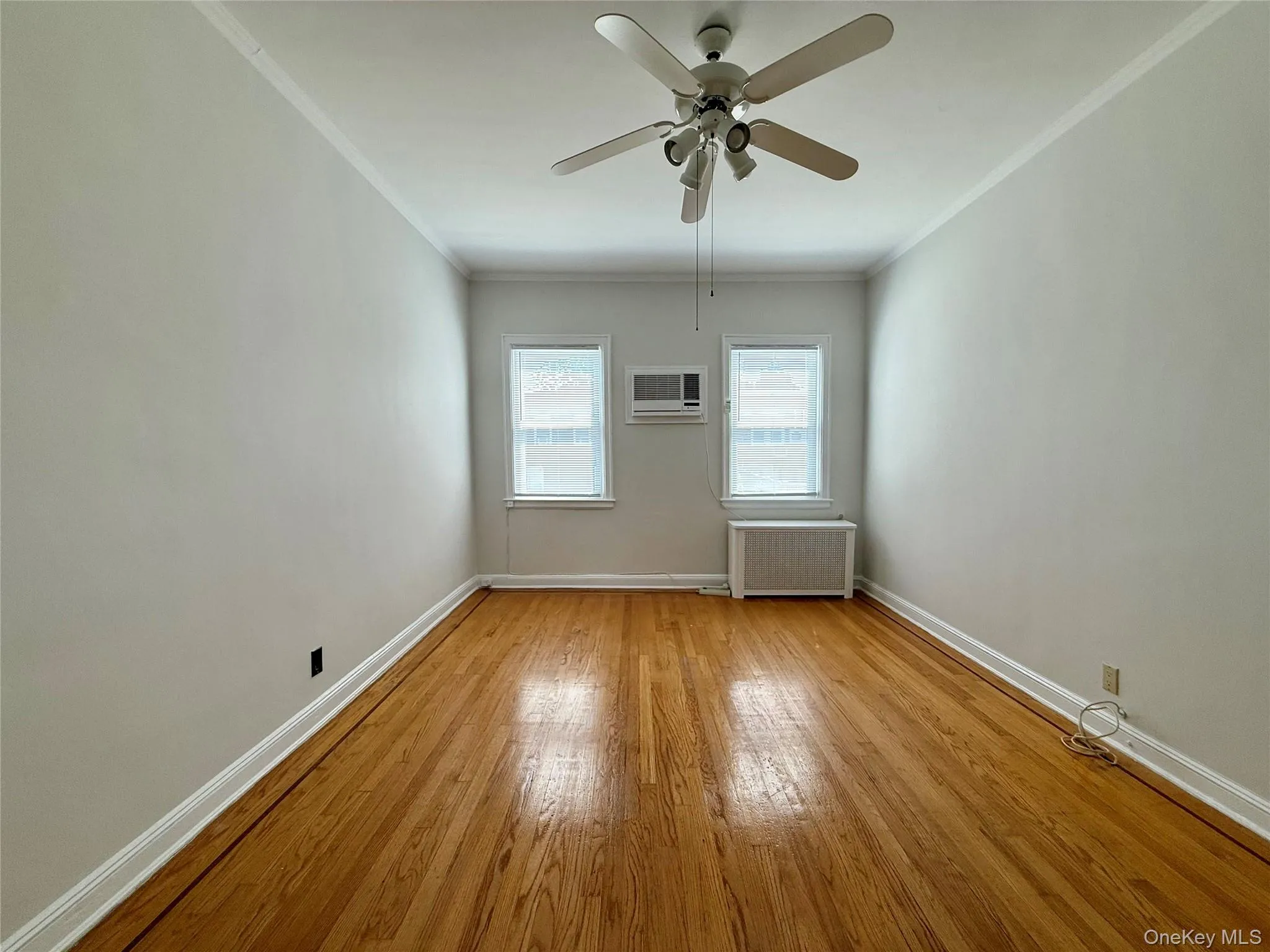 Large bedroom with 2 windows, wall air conditioner, elegant hardwood floors, closet and ceiling fan/light Large bedroom with 2 windows, wall air conditioner, elegant hardwood floors, closet and ceiling fan/light