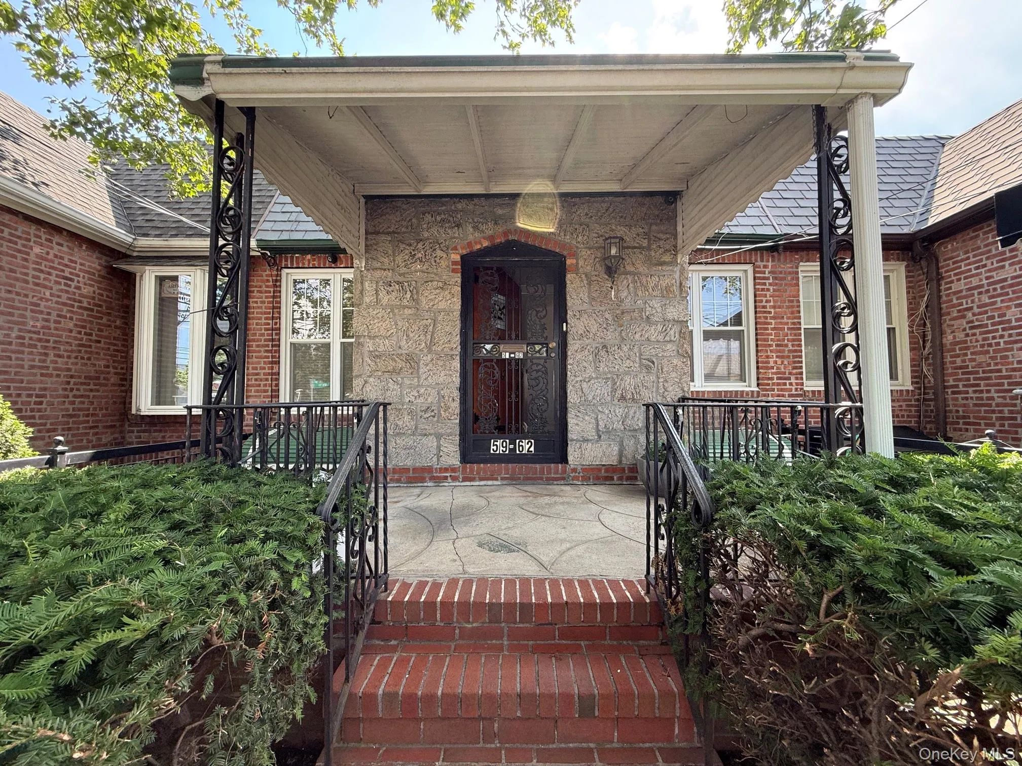 Welcoming brick and stone facade with a covered porch Welcoming brick and stone facade with a covered porch