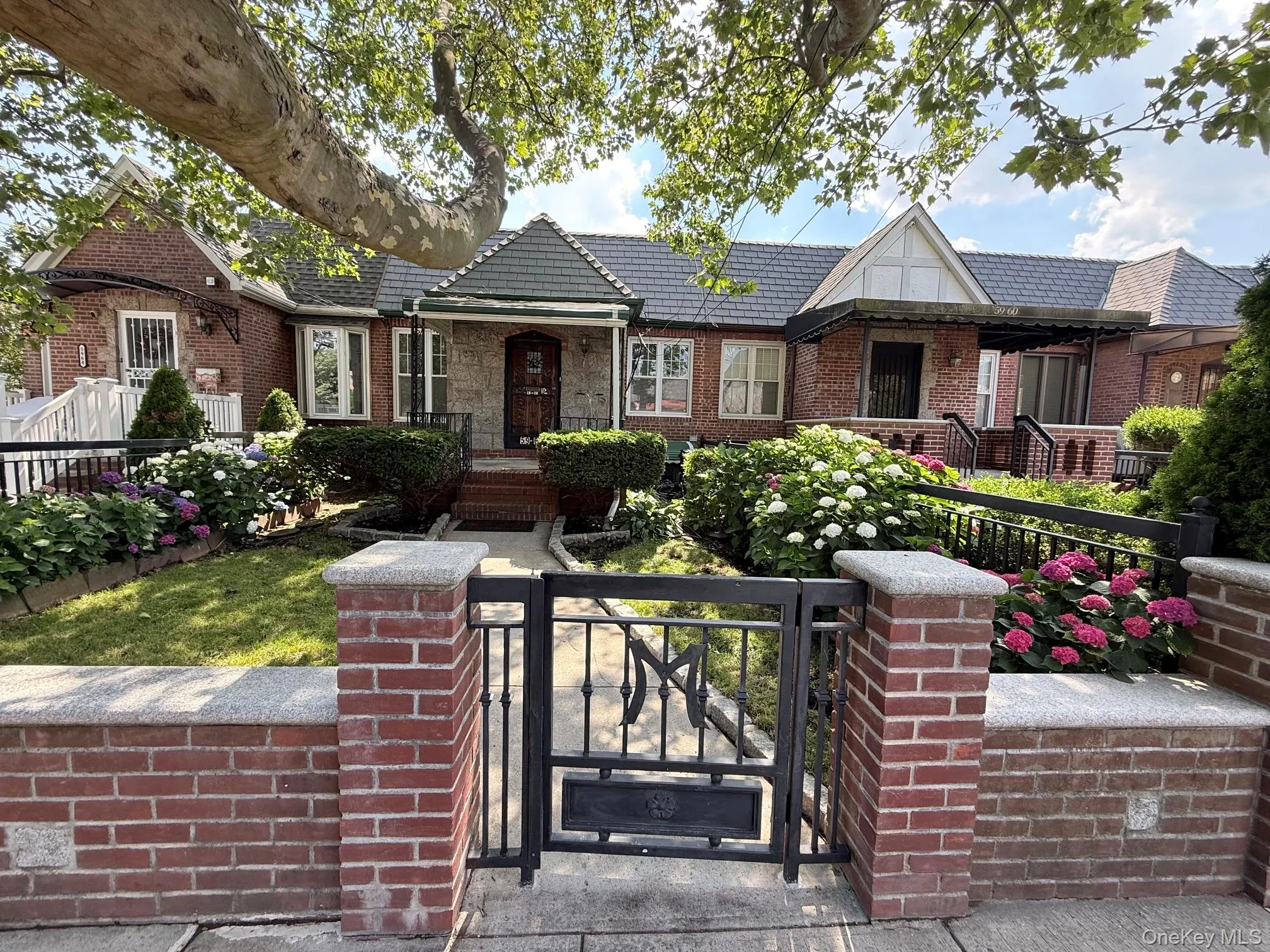 Large front yard with a brick fence and metal door Large front yard with a brick fence and metal door