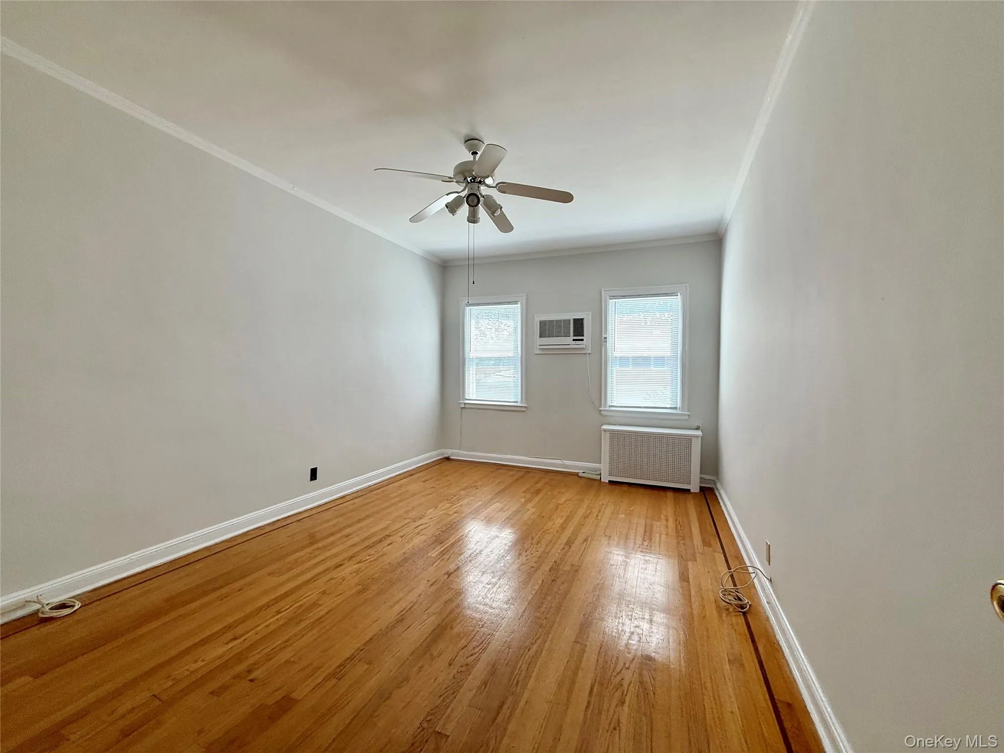 Large bedroom with 2 windows, wall air conditioner, elegant hardwood floors, closet and ceiling fan/light Large bedroom with 2 windows, wall air conditioner, elegant hardwood floors, closet and ceiling fan/light