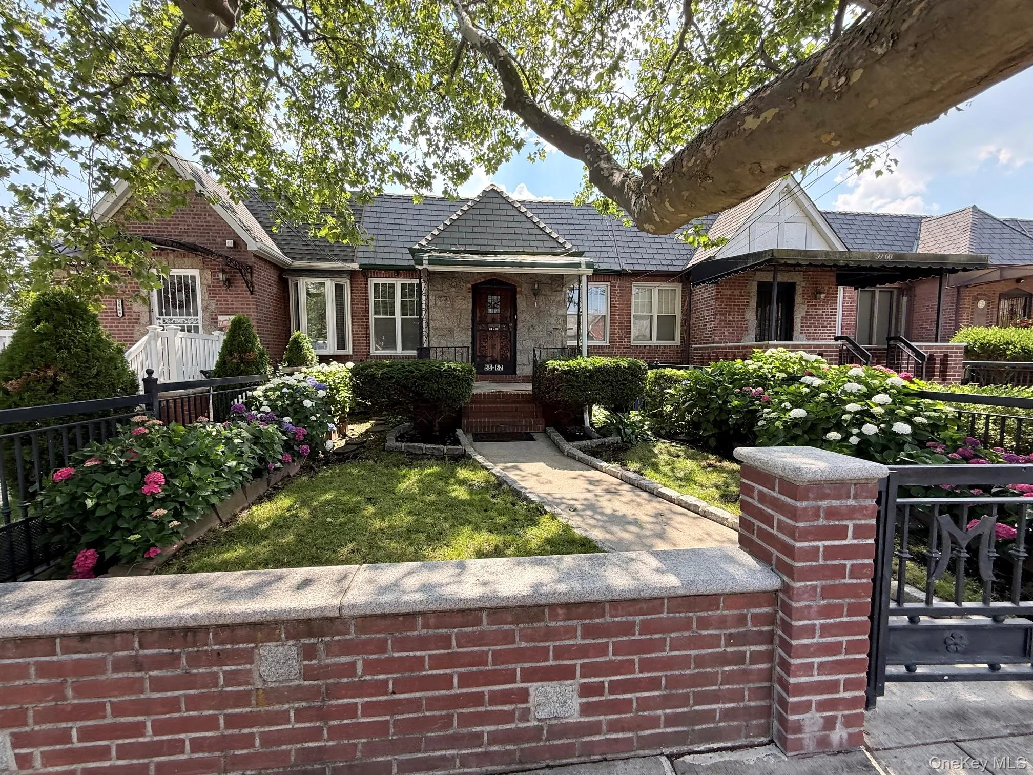 Large front yard with a brick fence and metal door Large front yard with a brick fence and metal door