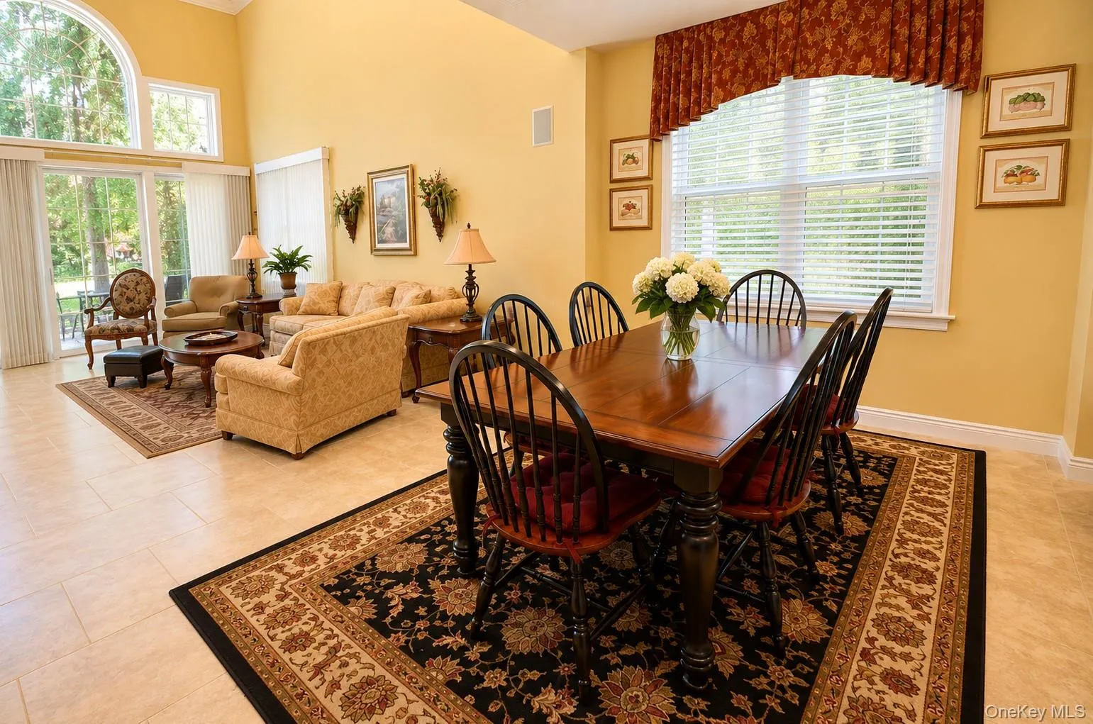 Open-concept living and dining areas featuring tile flooring Open-concept living and dining areas featuring tile flooring