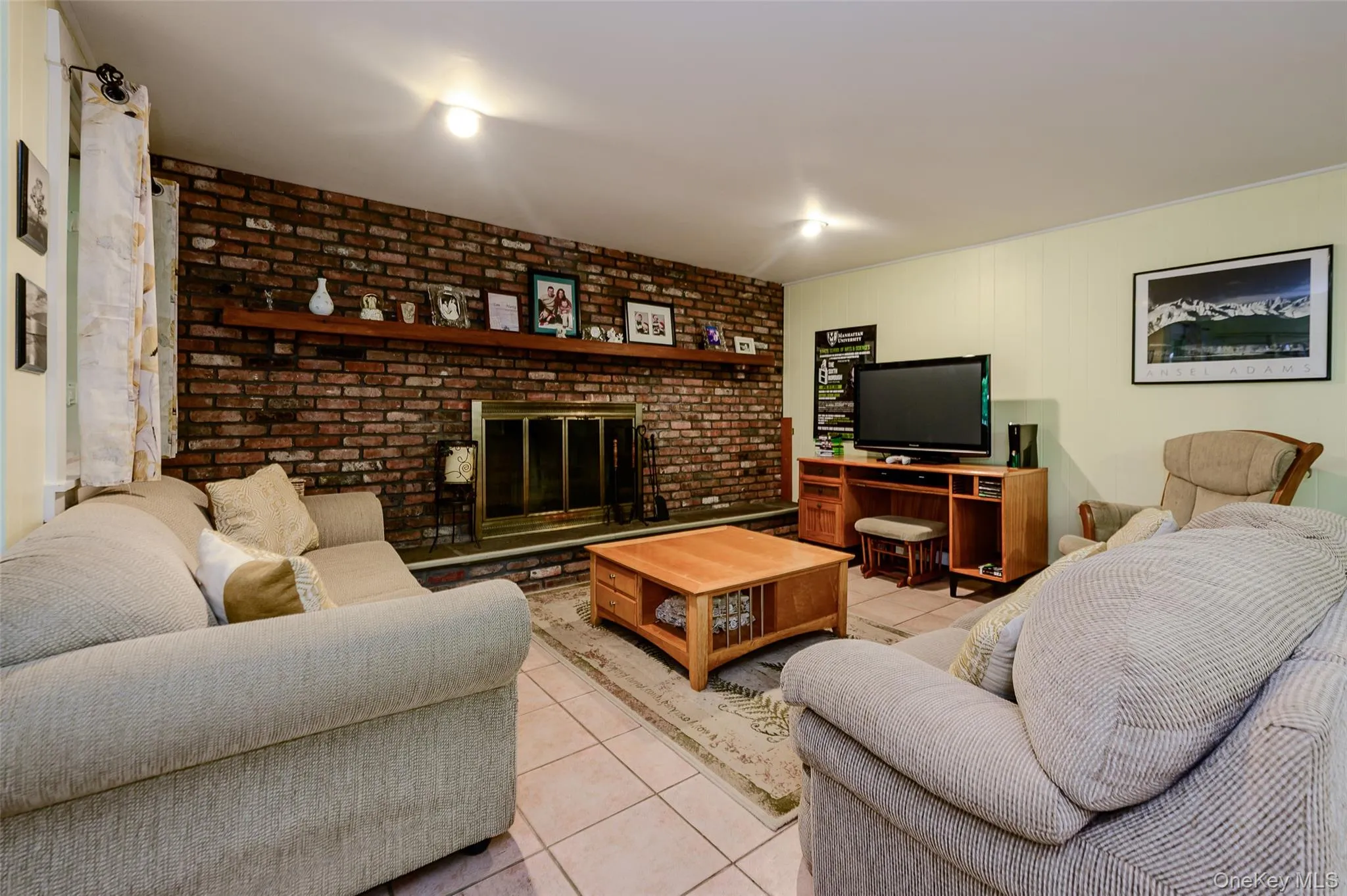 Lower-level family room with wood-burning fireplace. Lower-level family room with wood-burning fireplace.