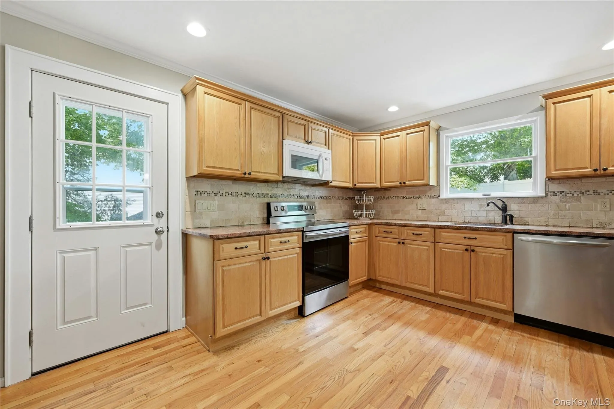 Kitchen with stainless steel appliances, door to the deck Kitchen with stainless steel appliances, door to the deck
