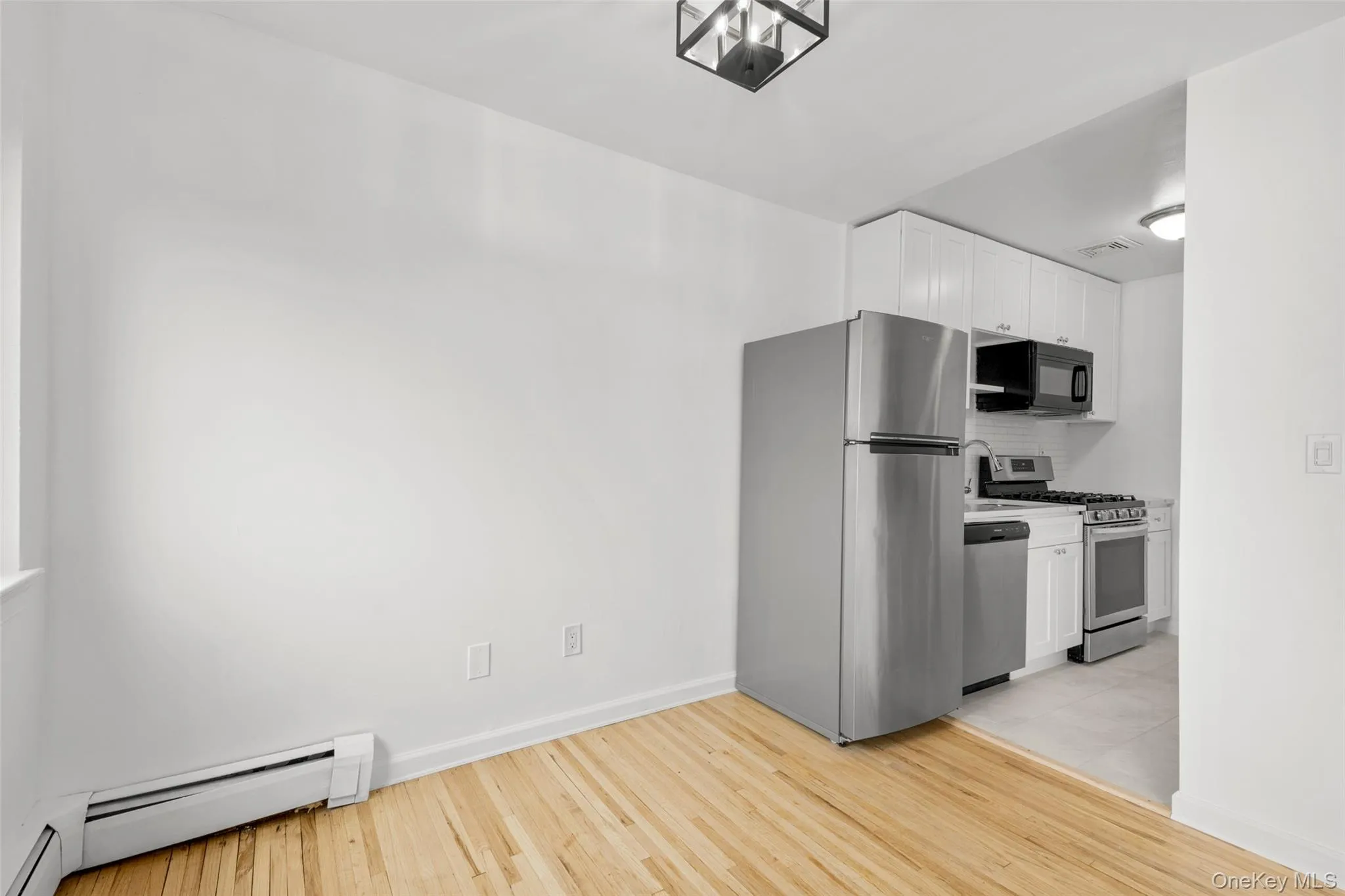 View of kitchen from dining area. View of kitchen from dining area.