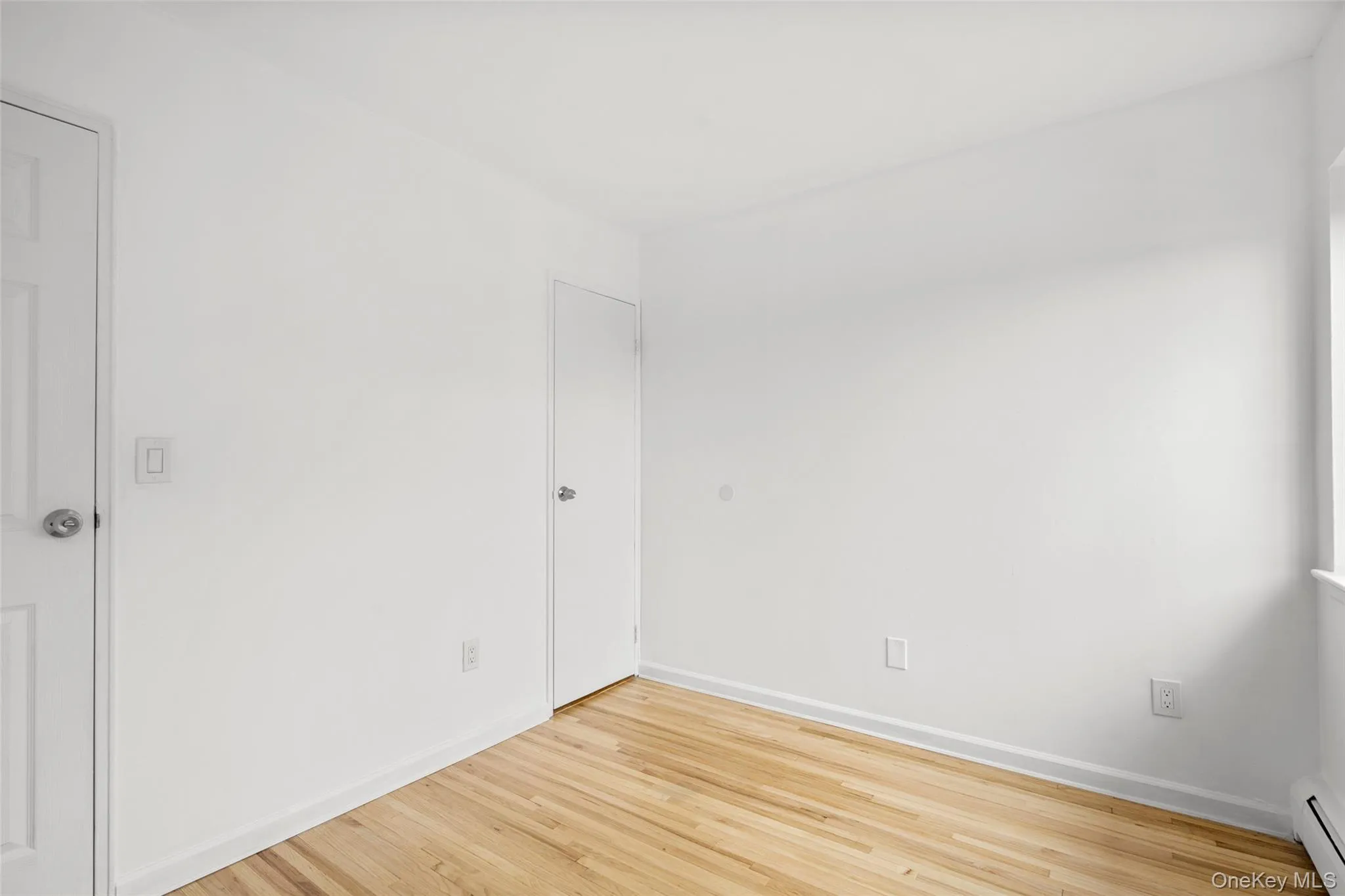 View of second bedroom from the corner of the room. Freshly painted walls with hard wood floors and ample closet space. View of second bedroom from the corner of the room. Freshly painted walls with hard wood floors and ample closet space.