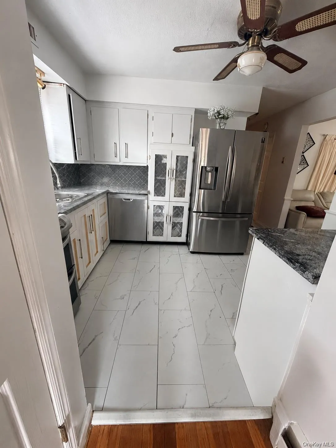 Modern kitchen featuring white cabinetry and stainless steel appliances Modern kitchen featuring white cabinetry and stainless steel appliances