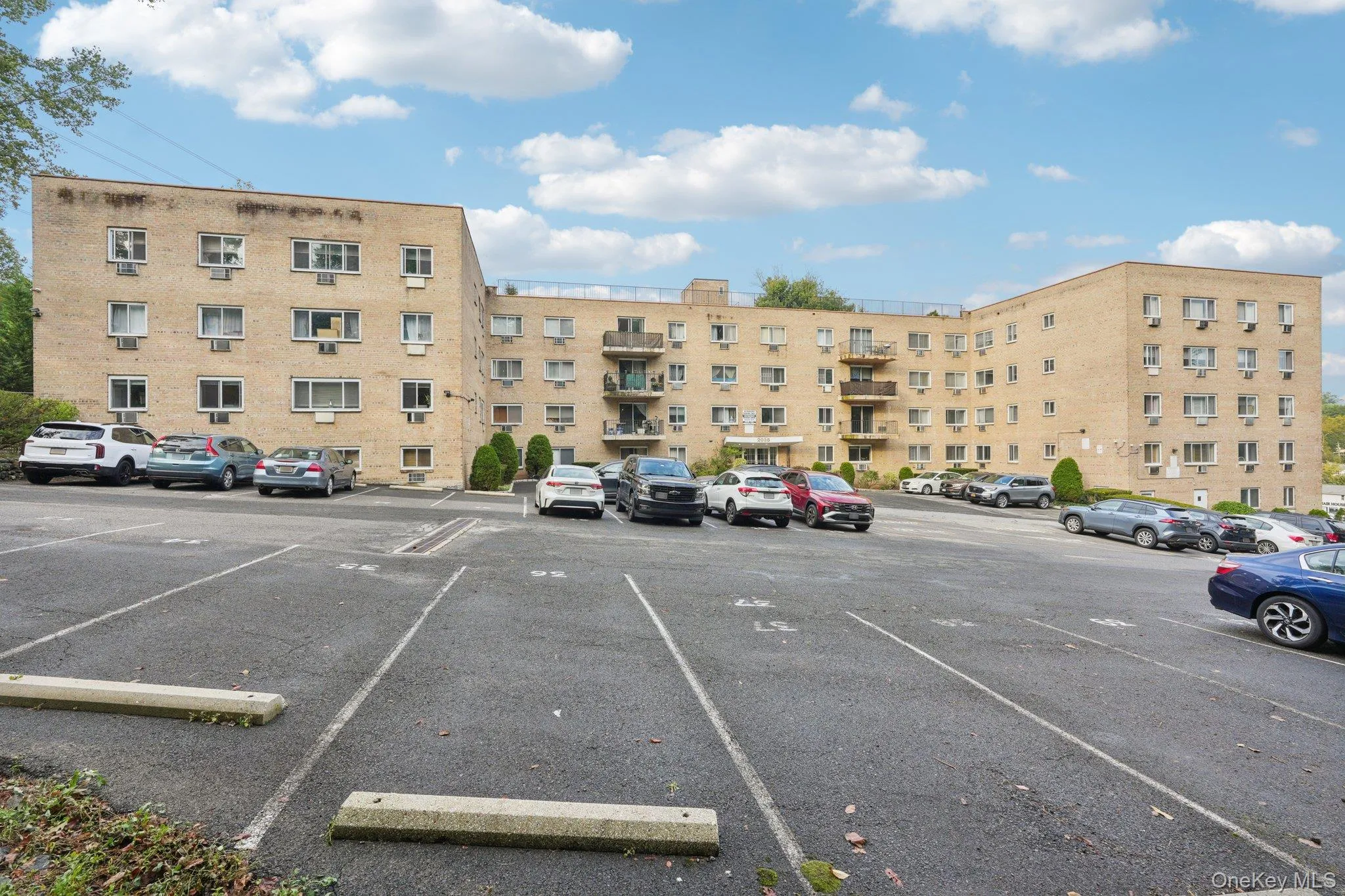 View of the apartment building and part of the parking lot View of the apartment building and part of the parking lot