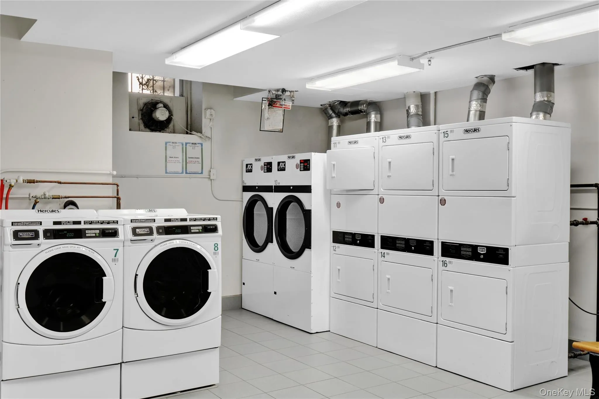 Shared laundry room with light tile patterned floors, stacked washer / drying machine, and washer and clothes dryer Shared laundry room with light tile patterned floors, stacked washer / drying machine, and washer and clothes dryer