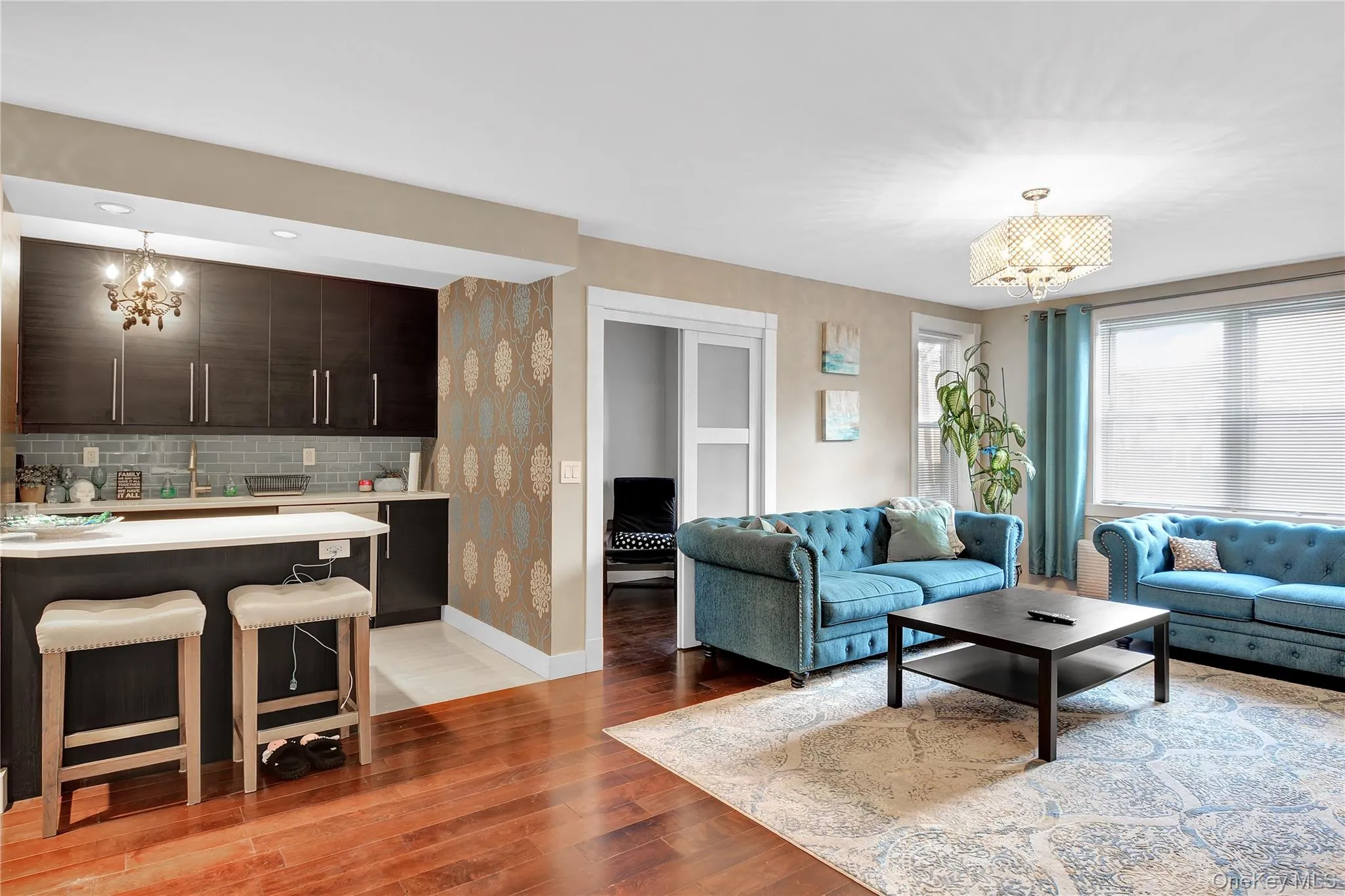 Living area featuring a chandelier, light wood-style floors, and recessed lighting Living area featuring a chandelier, light wood-style floors, and recessed lighting