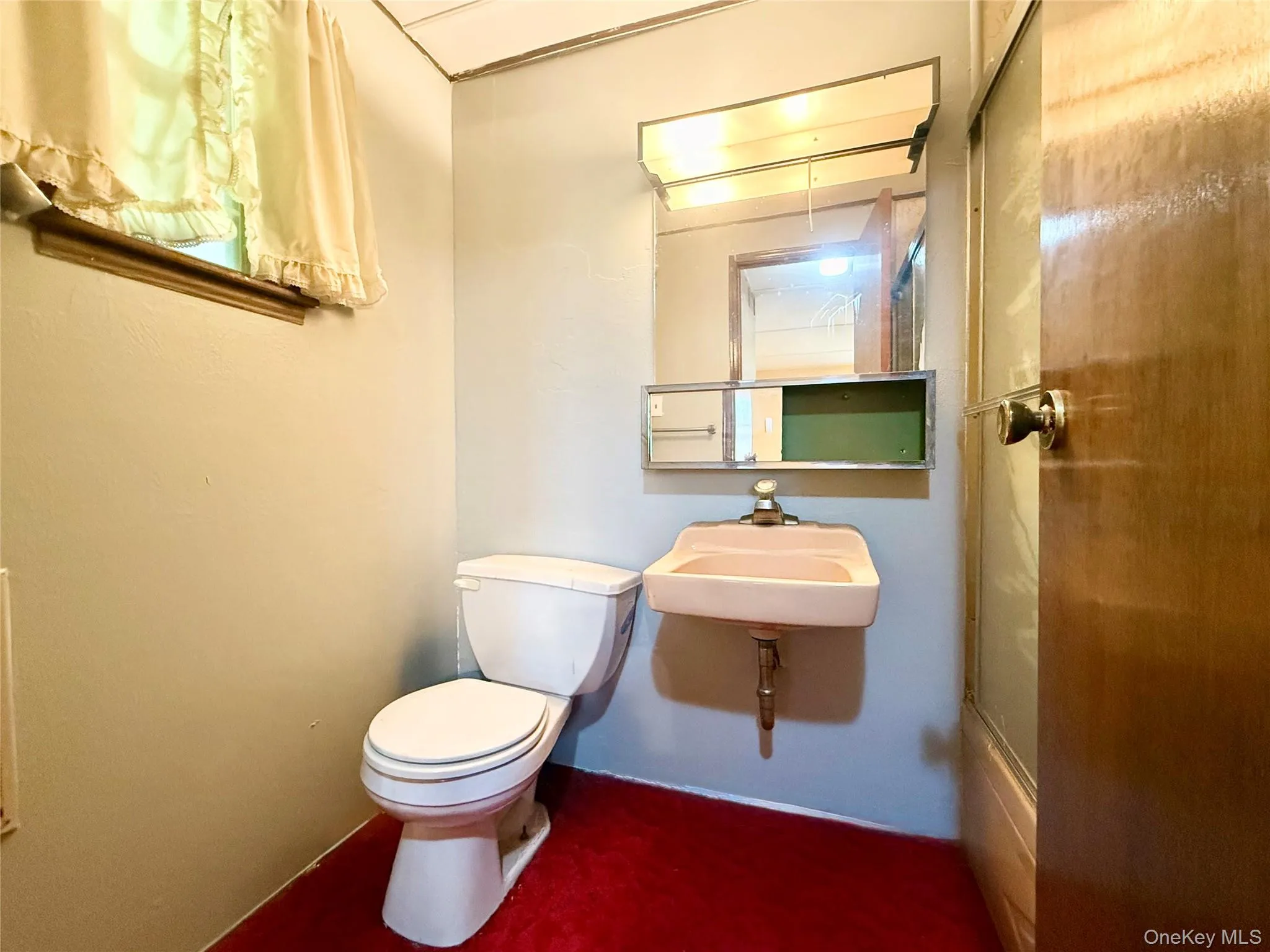 Bathroom with toilet and a sink Bathroom with toilet and a sink