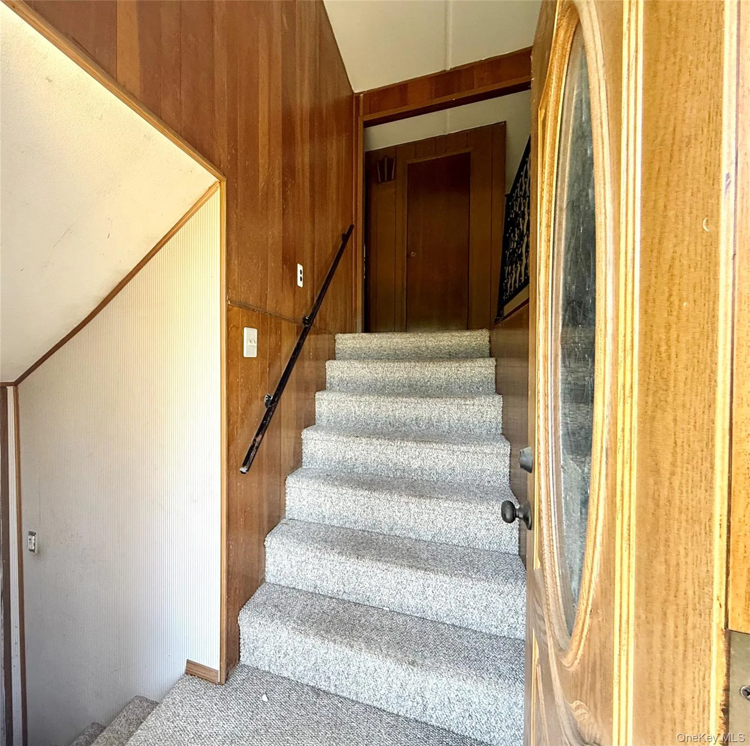 Stairway featuring carpet floors Stairway featuring carpet floors