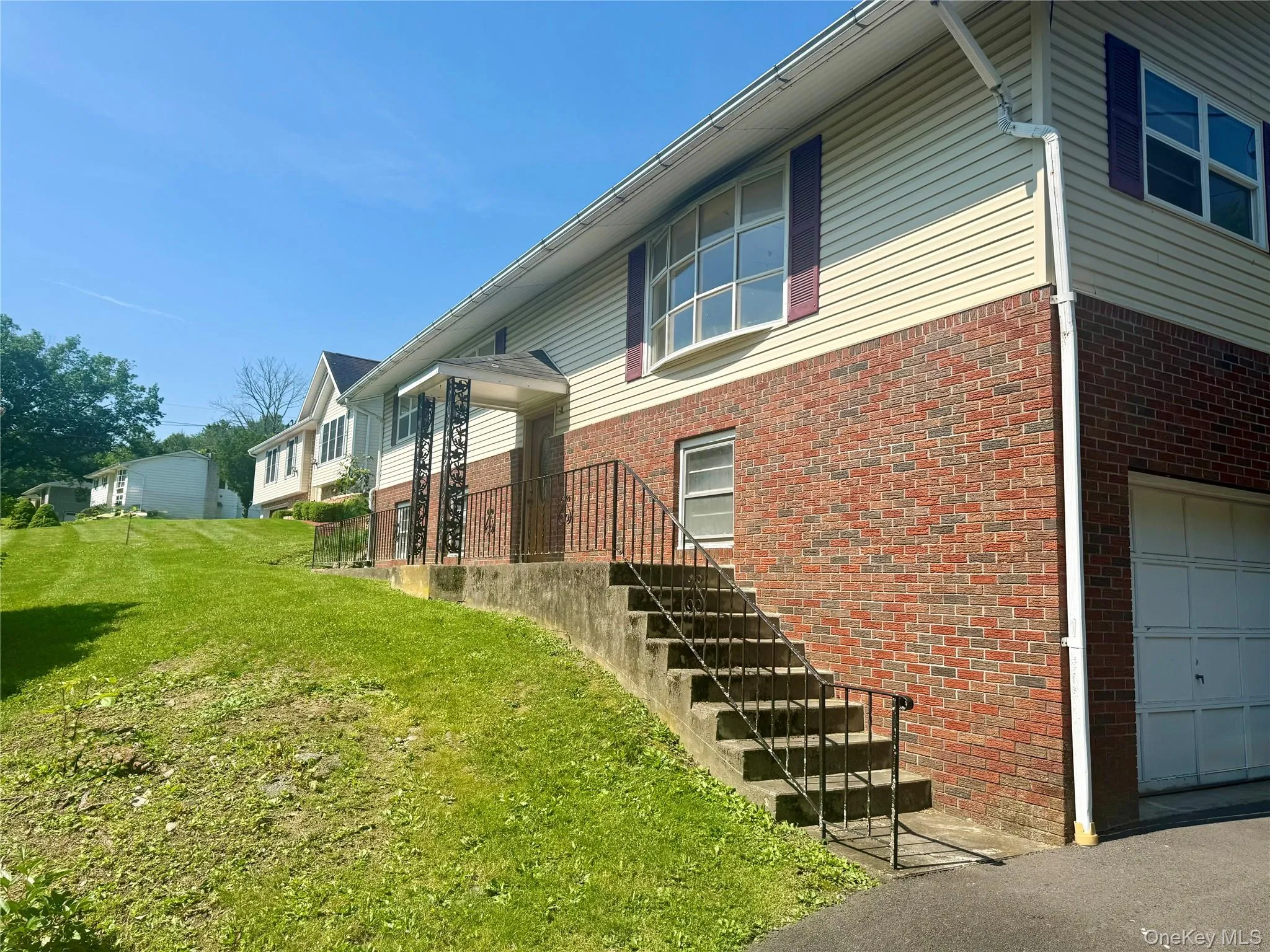 View of home's exterior with brick siding, a yard, and an attached garage View of home's exterior with brick siding, a yard, and an attached garage