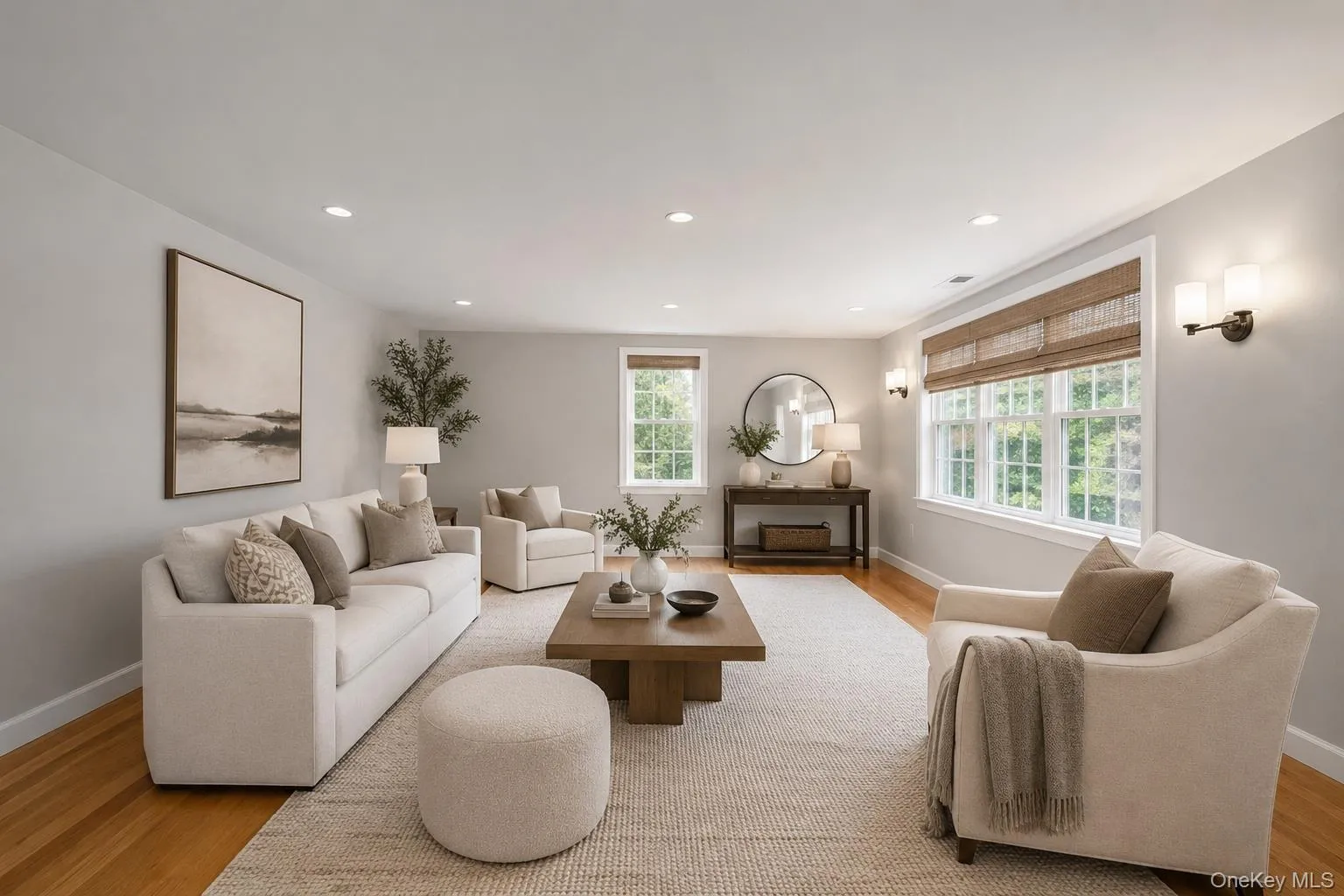 Living area featuring wood-finish flooring, recessed lighting, and expansive windows Living area featuring wood-finish flooring, recessed lighting, and expansive windows
