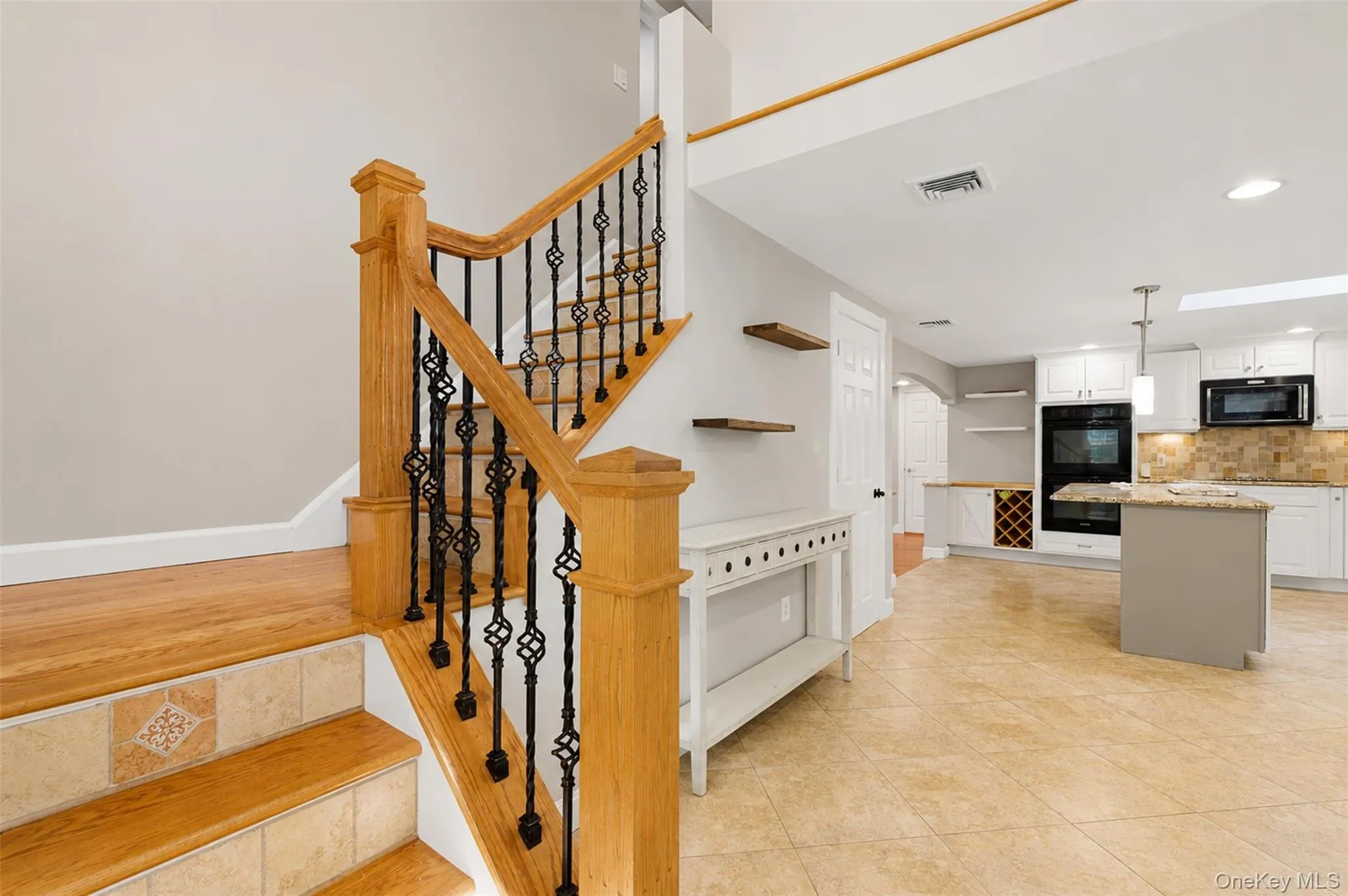 Hardwood staircase featuring wrought iron balusters and tiled risers Hardwood staircase featuring wrought iron balusters and tiled risers