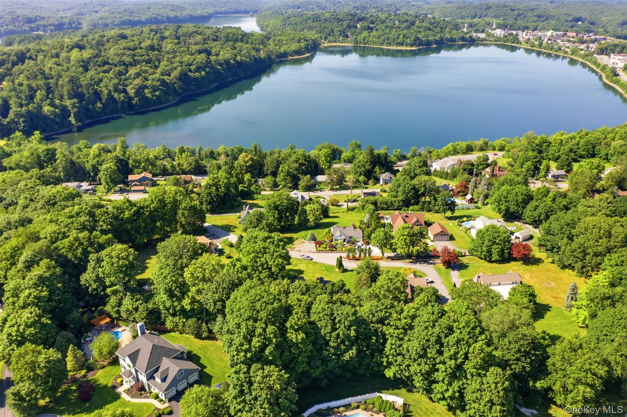 Elevated aerial perspective showcasing a residential area with a prominent body of water Elevated aerial perspective showcasing a residential area with a prominent body of water