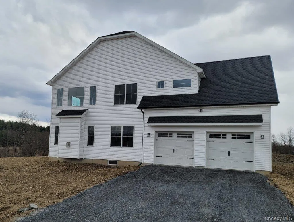 Side view featuring the two car garage, timeless Colonial styling enhanced by modern finished. Side view featuring the two car garage, timeless Colonial styling enhanced by modern finished.
