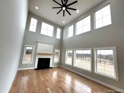 Dramatic great room featuring soaring ceilings and expansive windows that fill the living space with abundant natural light. Dramatic great room featuring soaring ceilings and expansive windows that fill the living space with abundant natural light.