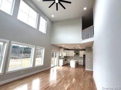 An alternate view of this gathering space highlighting the open-concept design and seamless connection between main living areas. An alternate view of this gathering space highlighting the open-concept design and seamless connection between main living areas.