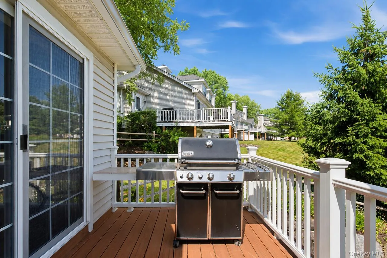 Outdoor deck featuring wood-finish flooring and white railings Outdoor deck featuring wood-finish flooring and white railings