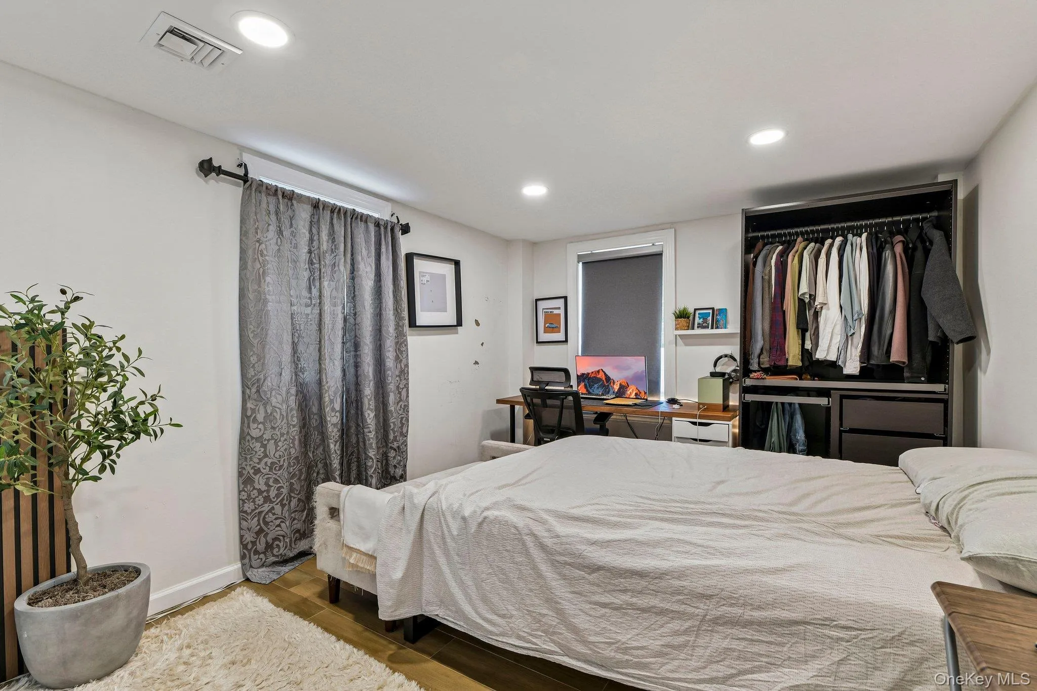 Bright interior space featuring recessed lighting and wood-finish flooring Bright interior space featuring recessed lighting and wood-finish flooring