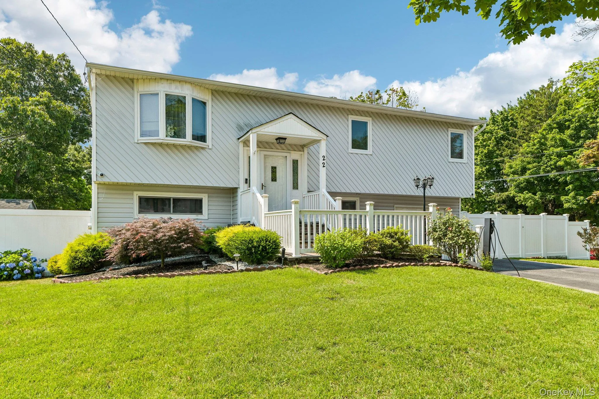 Split-level residence featuring light-colored siding Split-level residence featuring light-colored siding
