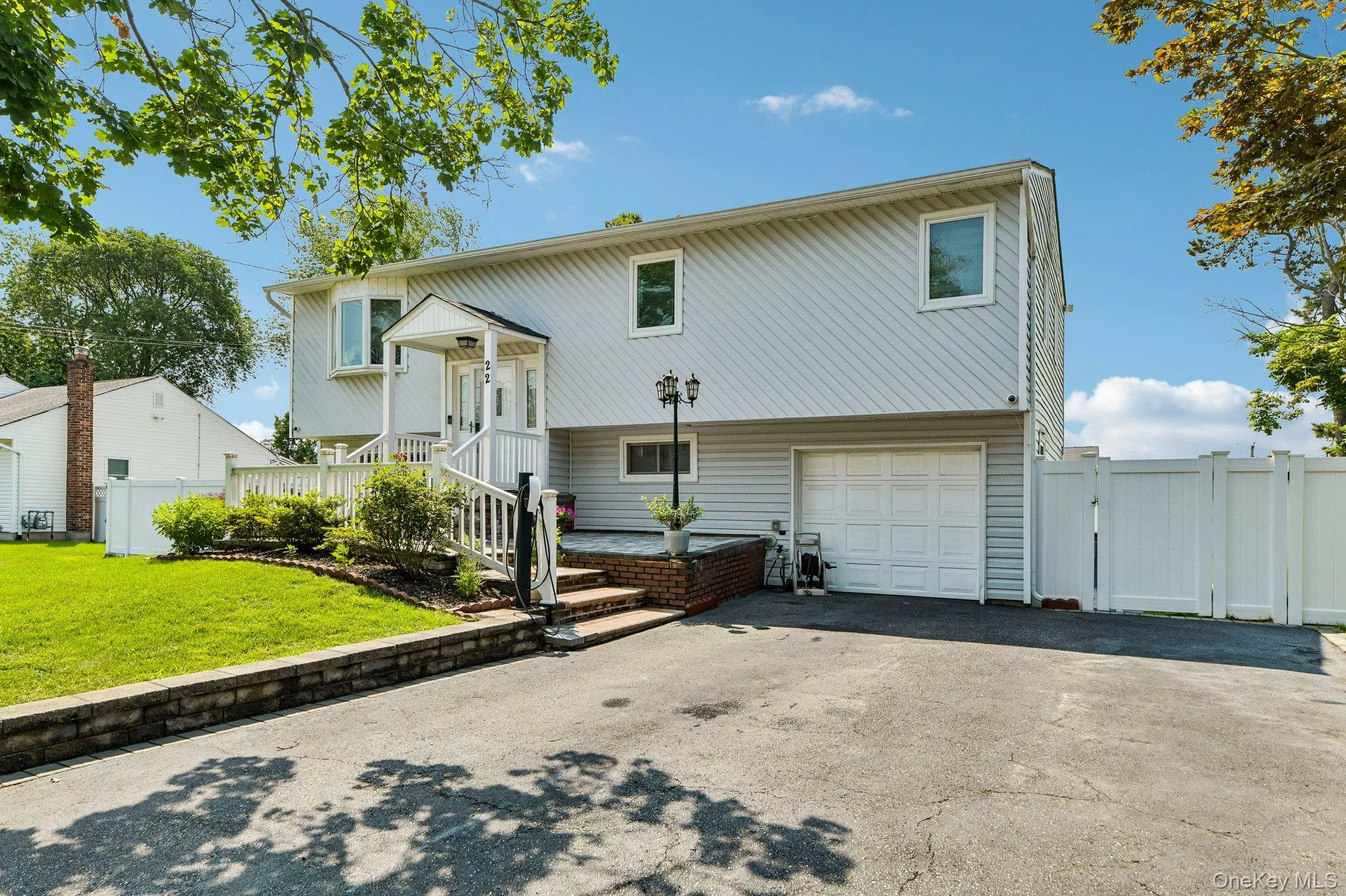 Split-level residence featuring light gray siding and white trim Split-level residence featuring light gray siding and white trim