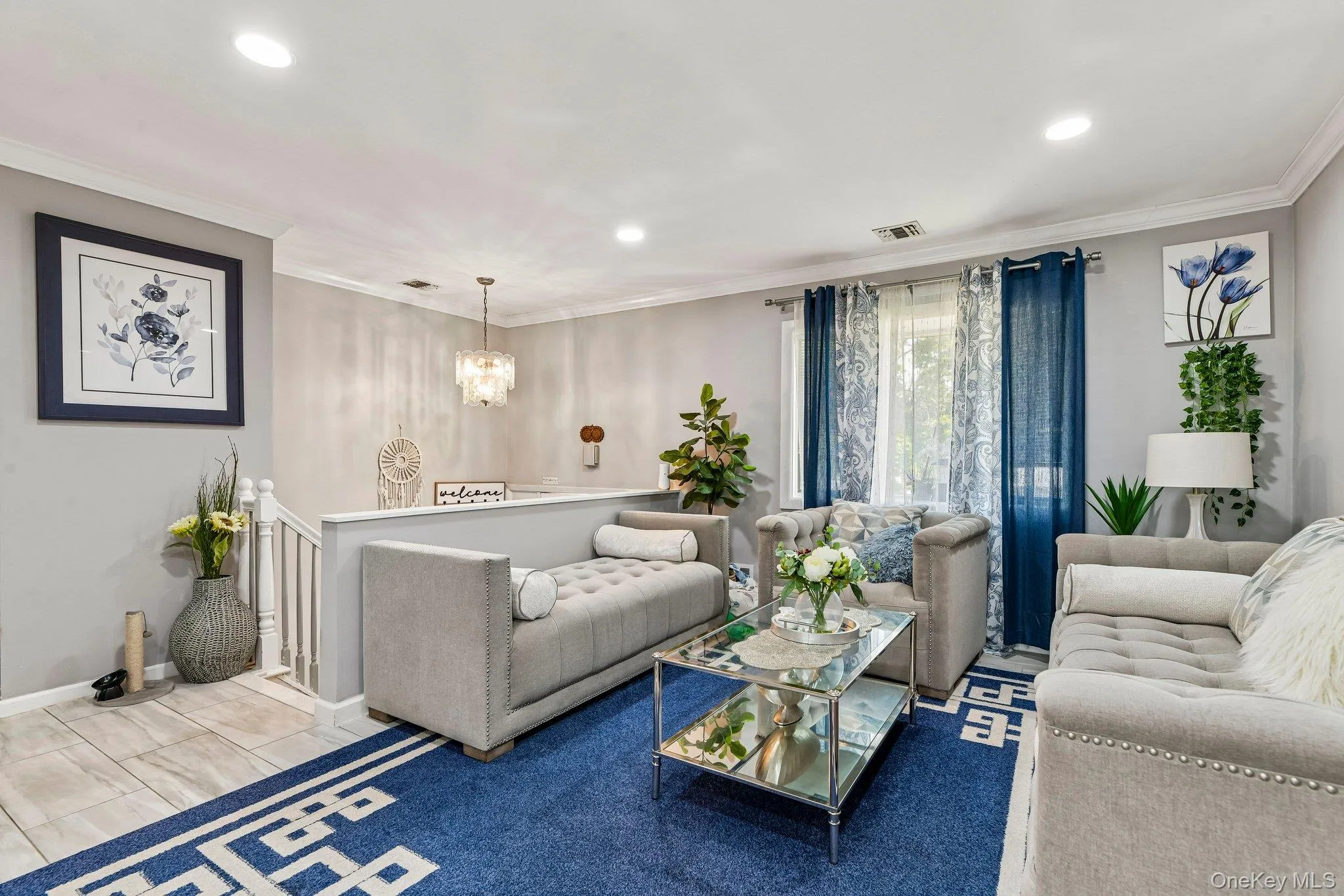 Inviting living area featuring recessed lighting, crown molding, and a chandelier Inviting living area featuring recessed lighting, crown molding, and a chandelier