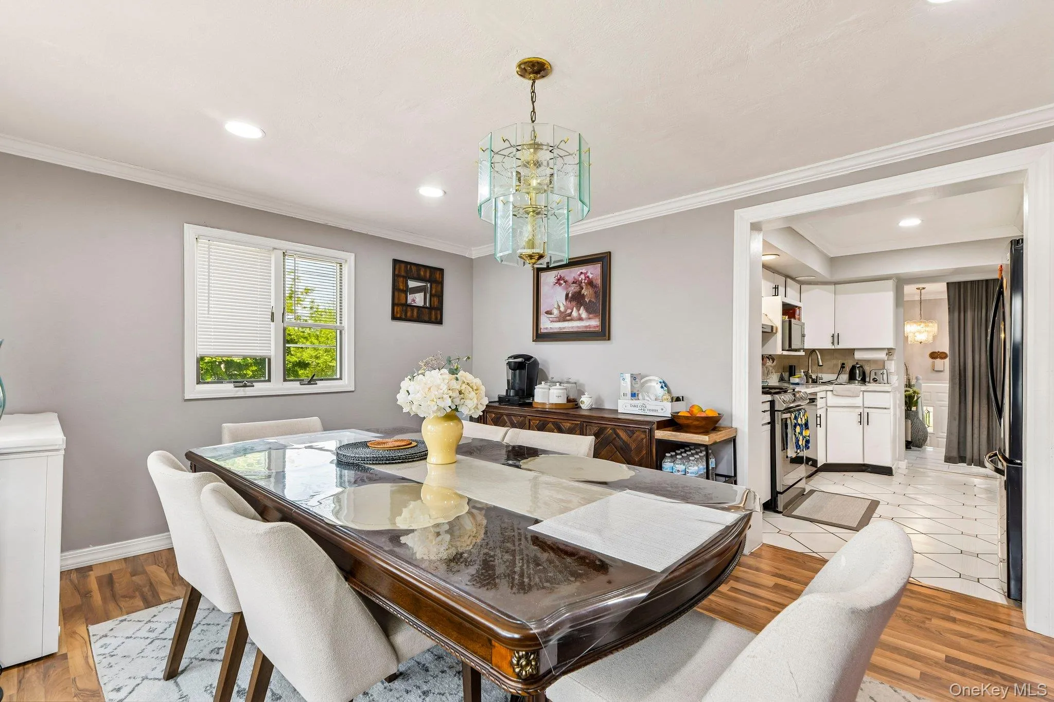 Dining area featuring wood-finish flooring, a contemporary chandelier, and recessed lighting Dining area featuring wood-finish flooring, a contemporary chandelier, and recessed lighting