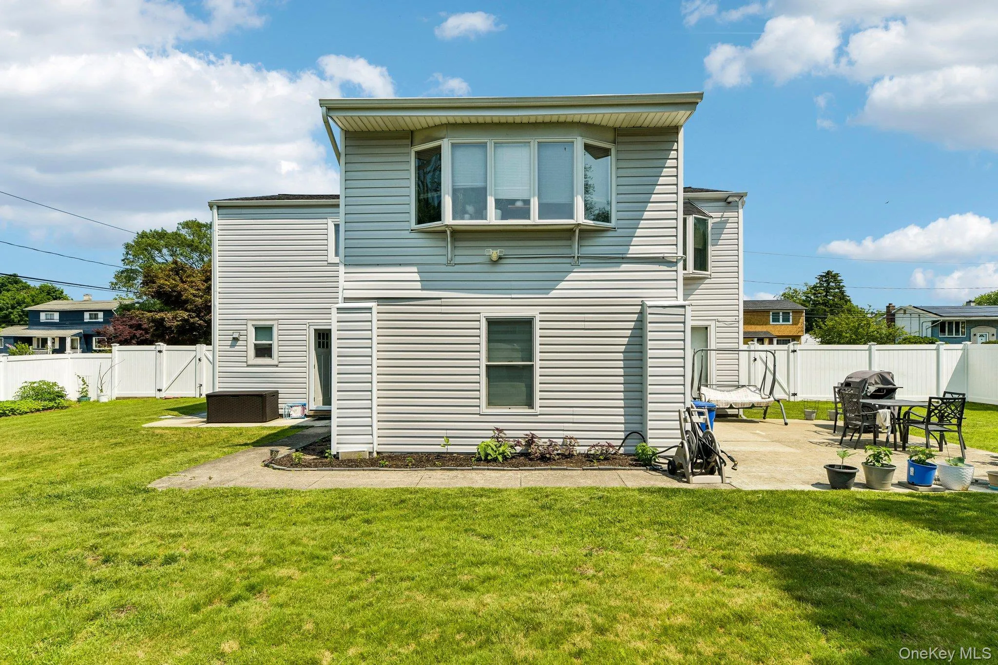 Residential siding exterior featuring a second-story bay window Residential siding exterior featuring a second-story bay window