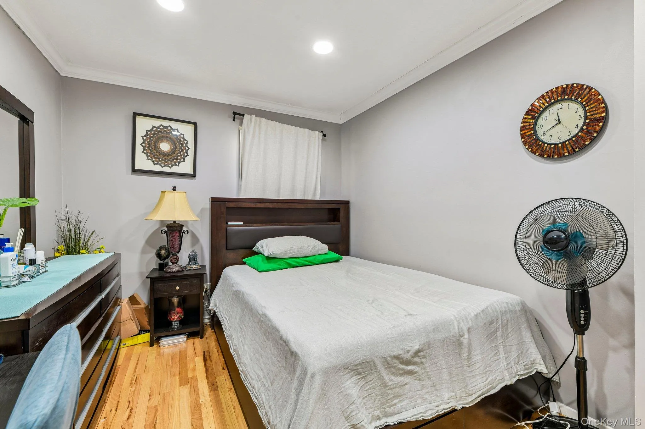 Interior room featuring wood-finish flooring, recessed lighting, and crown molding Interior room featuring wood-finish flooring, recessed lighting, and crown molding