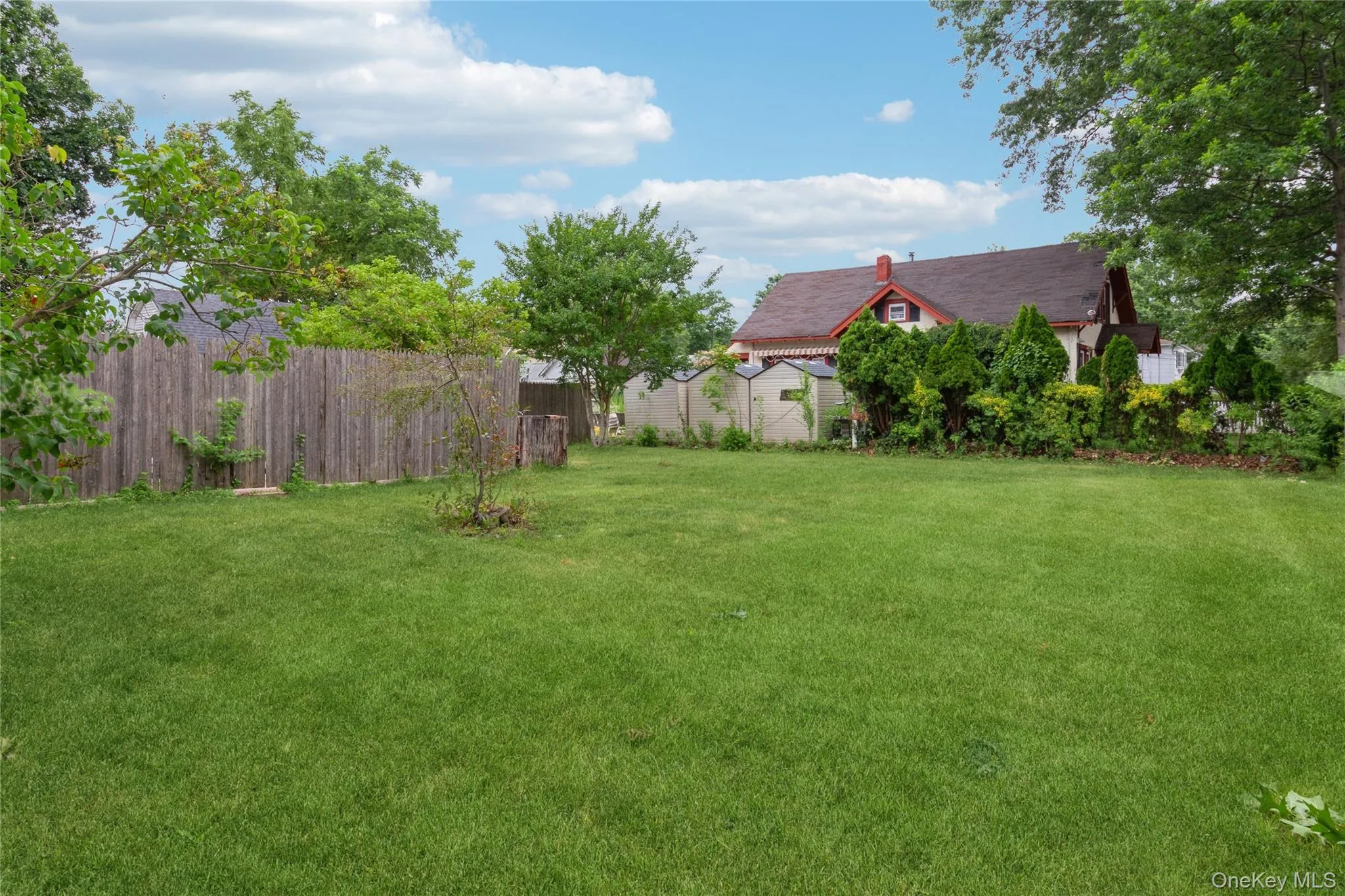 Expansive green lawn with mature trees Expansive green lawn with mature trees