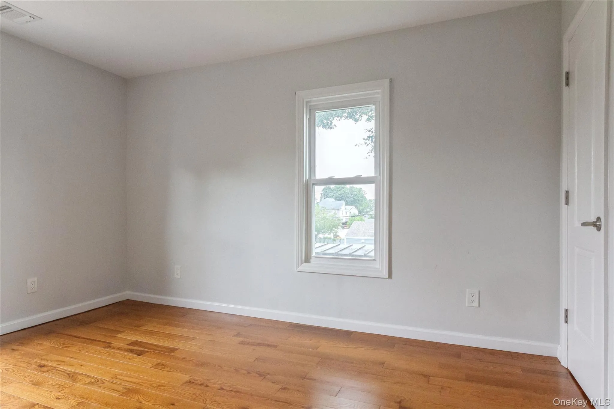 Hardwood-finish flooring enhancing a light-filled upstairs bedroom Hardwood-finish flooring enhancing a light-filled upstairs bedroom