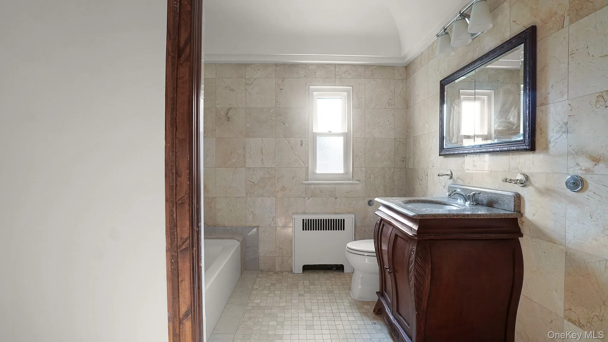 Bathroom featuring stone tile walls and flooring Bathroom featuring stone tile walls and flooring
