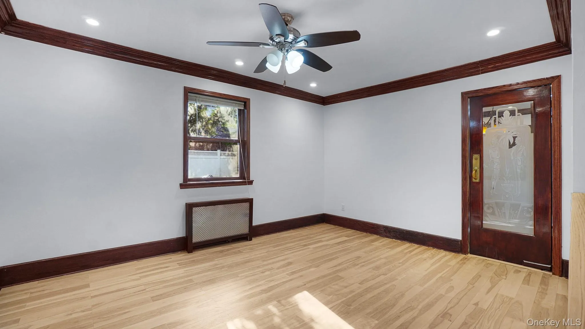 Wood-finish flooring with rich dark wood trim and a coordinating ceiling fan Wood-finish flooring with rich dark wood trim and a coordinating ceiling fan