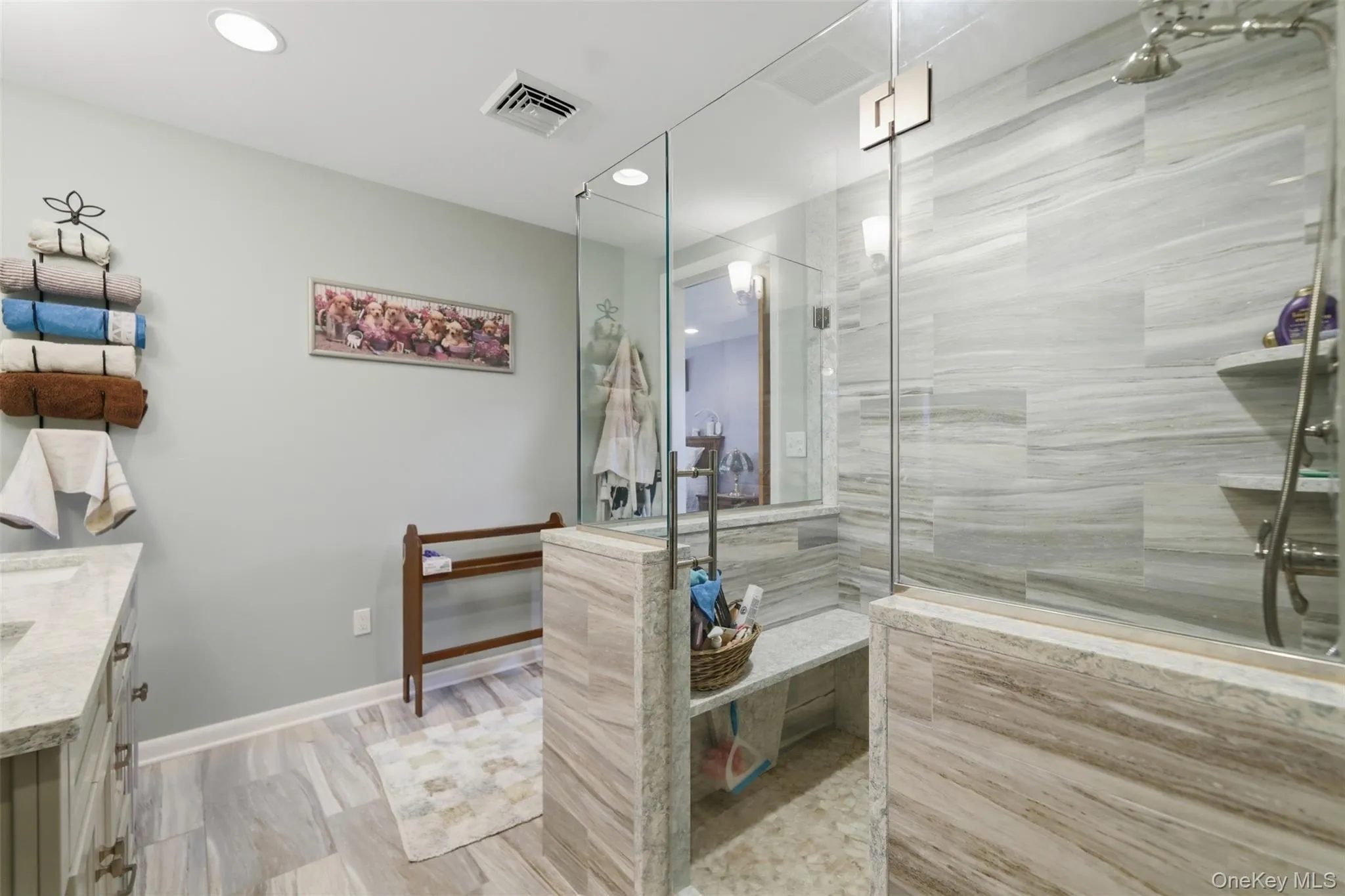 Spacious shower enclosure with glass panels and a built-in bench Spacious shower enclosure with glass panels and a built-in bench