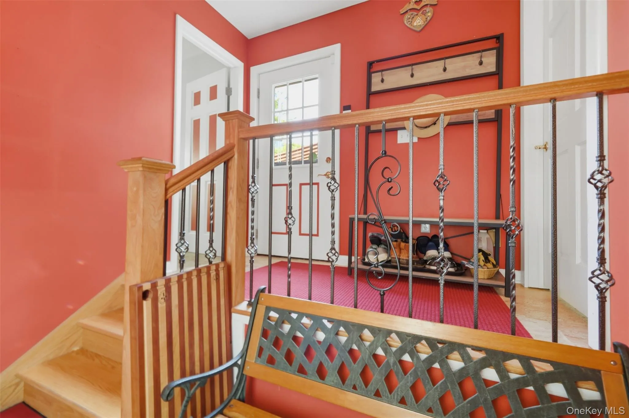 Hardwood staircase with wrought iron balusters and a wood-finish handrail Hardwood staircase with wrought iron balusters and a wood-finish handrail