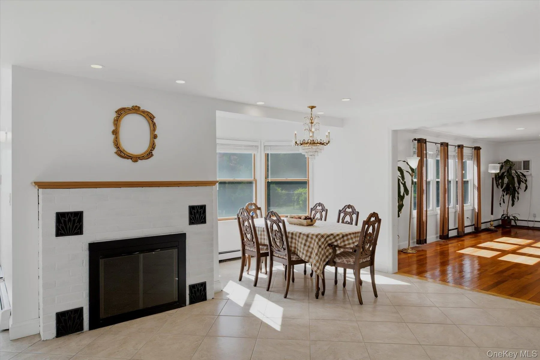Open floor plan with wood fireplace, dining room and living room Open floor plan with wood fireplace, dining room and living room