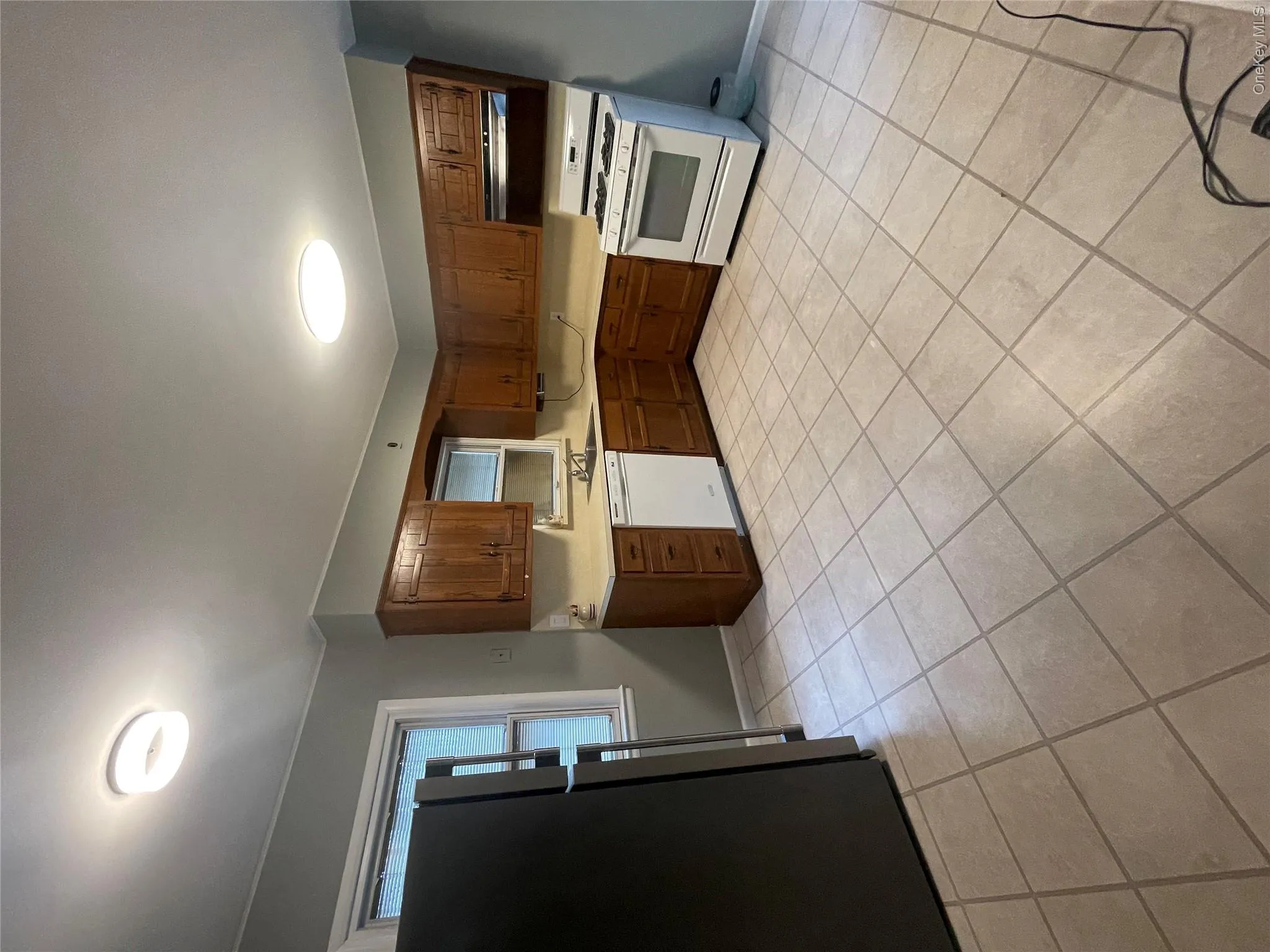 Kitchen featuring light countertops, stove, ventilation hood, dishwasher, and fridge Kitchen featuring light countertops, stove, ventilation hood, dishwasher, and fridge